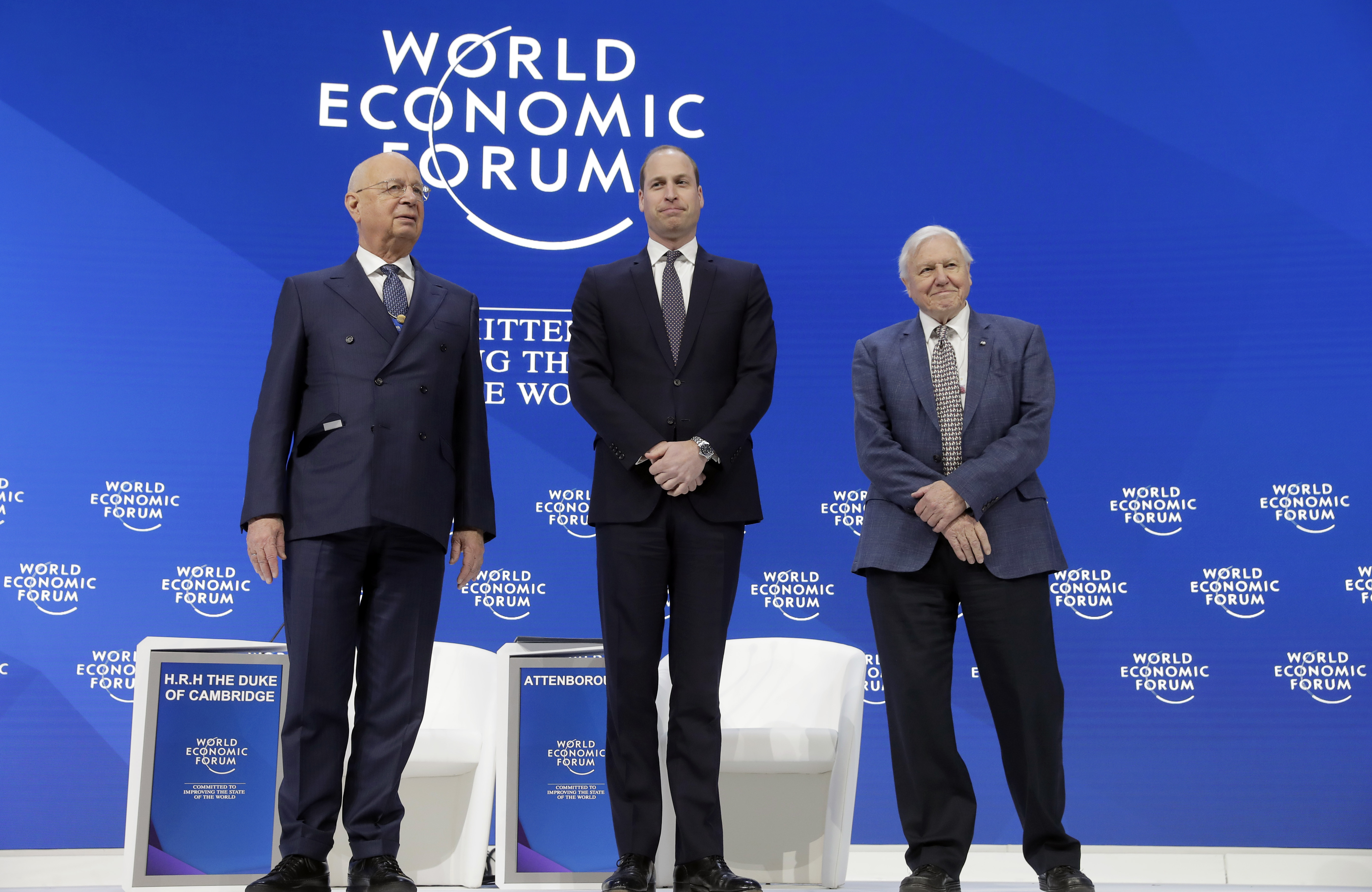 Klaus Schwab, founder and Executive Chairman of the World Economic Forum, Britain's Prince William, and Sir David Attenborough, broadcaster and natural historian, from left to right, stand together during a session at the annual meeting of the World Economic Forum in Davos, Switzerland, Tuesday, Jan. 22, 2019. (AP Photo/Markus Schreiber)