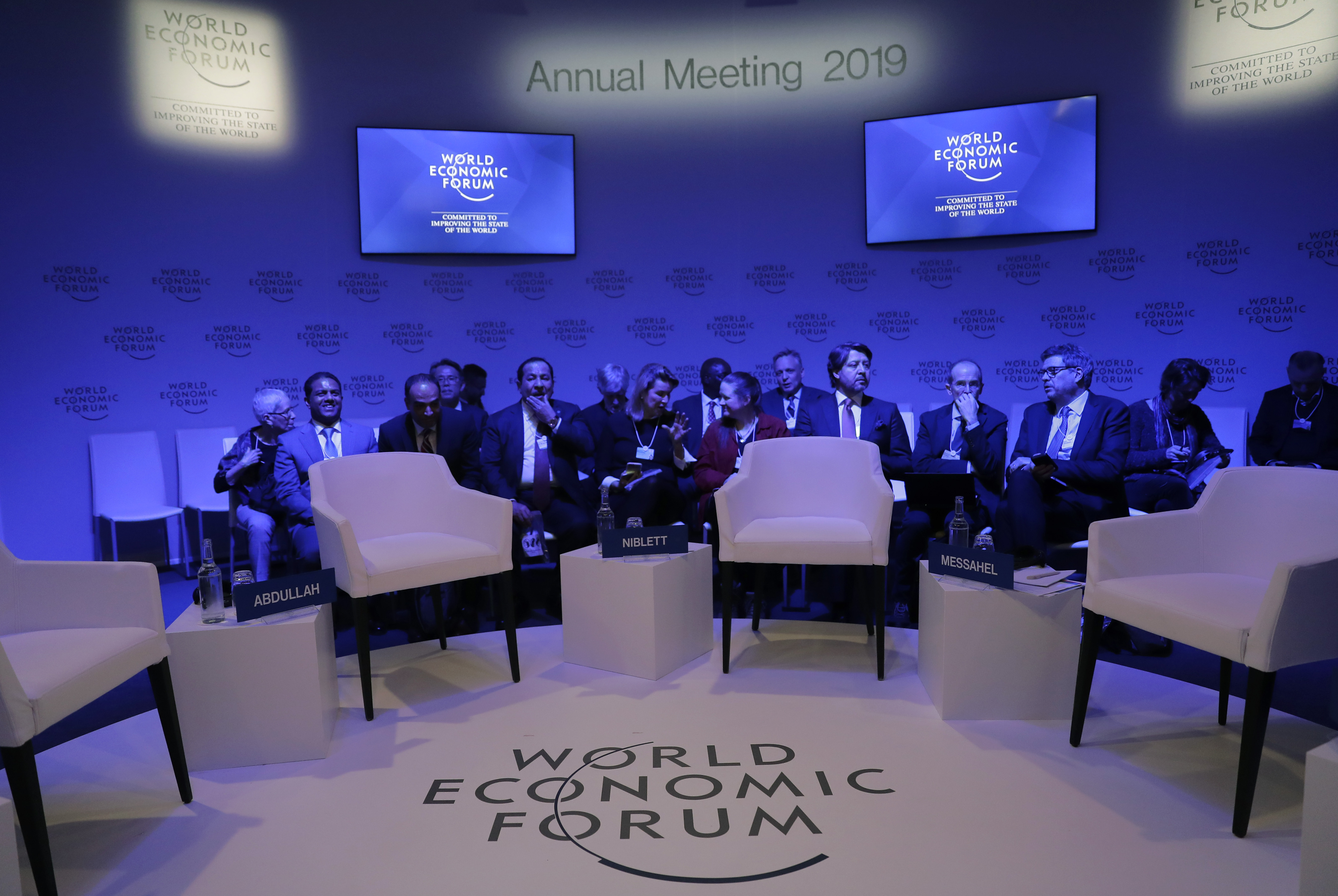 Attendees wait for the start of a session at the annual meeting of the World Economic Forum in Davos, Switzerland, Tuesday, Jan. 22, 2019. (AP Photo/Markus Schreiber)
