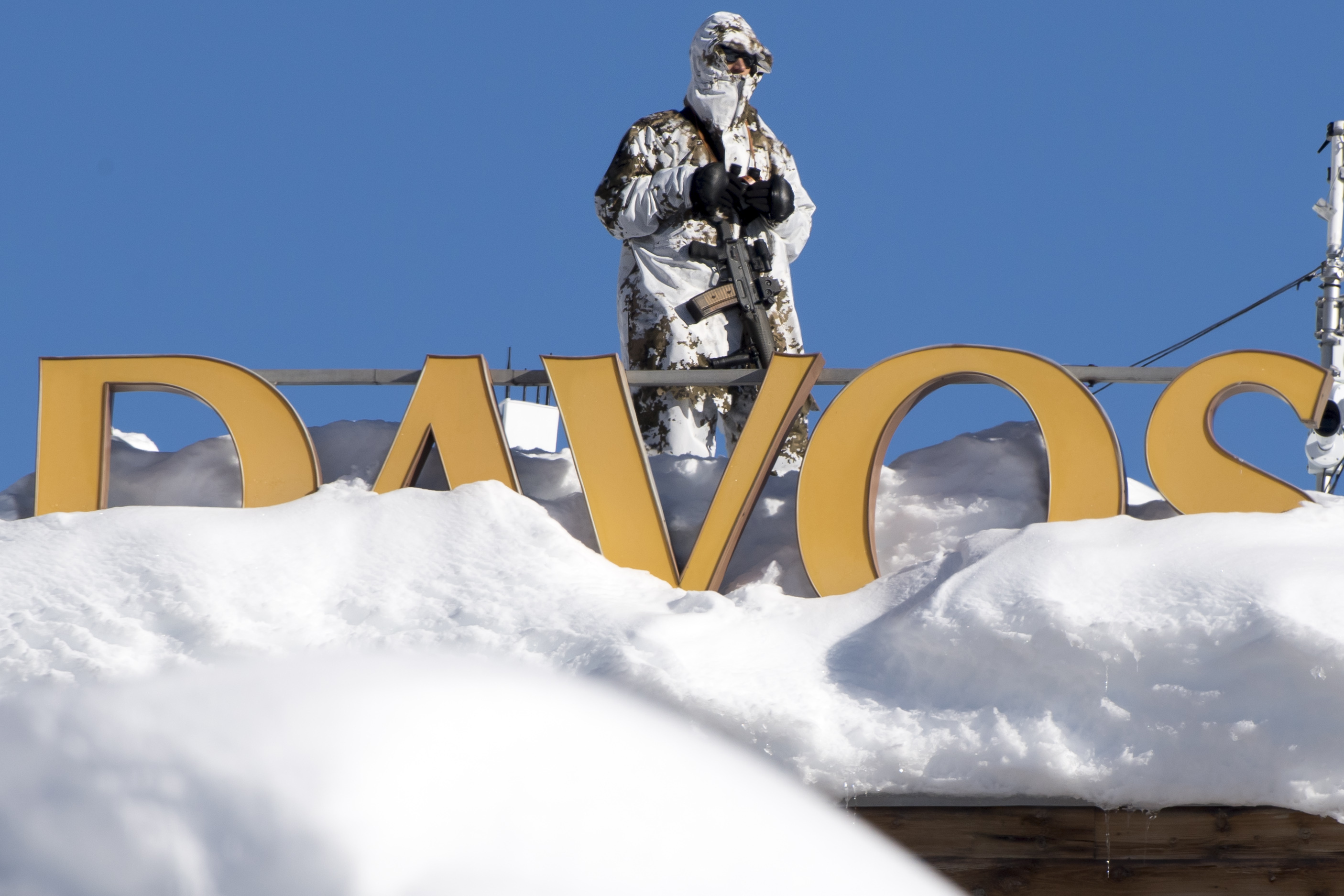 Member of Swiss special police forces stand on the roof of the Kongress Hotel next to the Congress Center the first day of the 49th Annual Meeting of the World Economic Forum, WEF, in Davos, Switzerland, Tuesday, Jan. 22, 2019. (Laurent Gillieron/Keystone via AP)