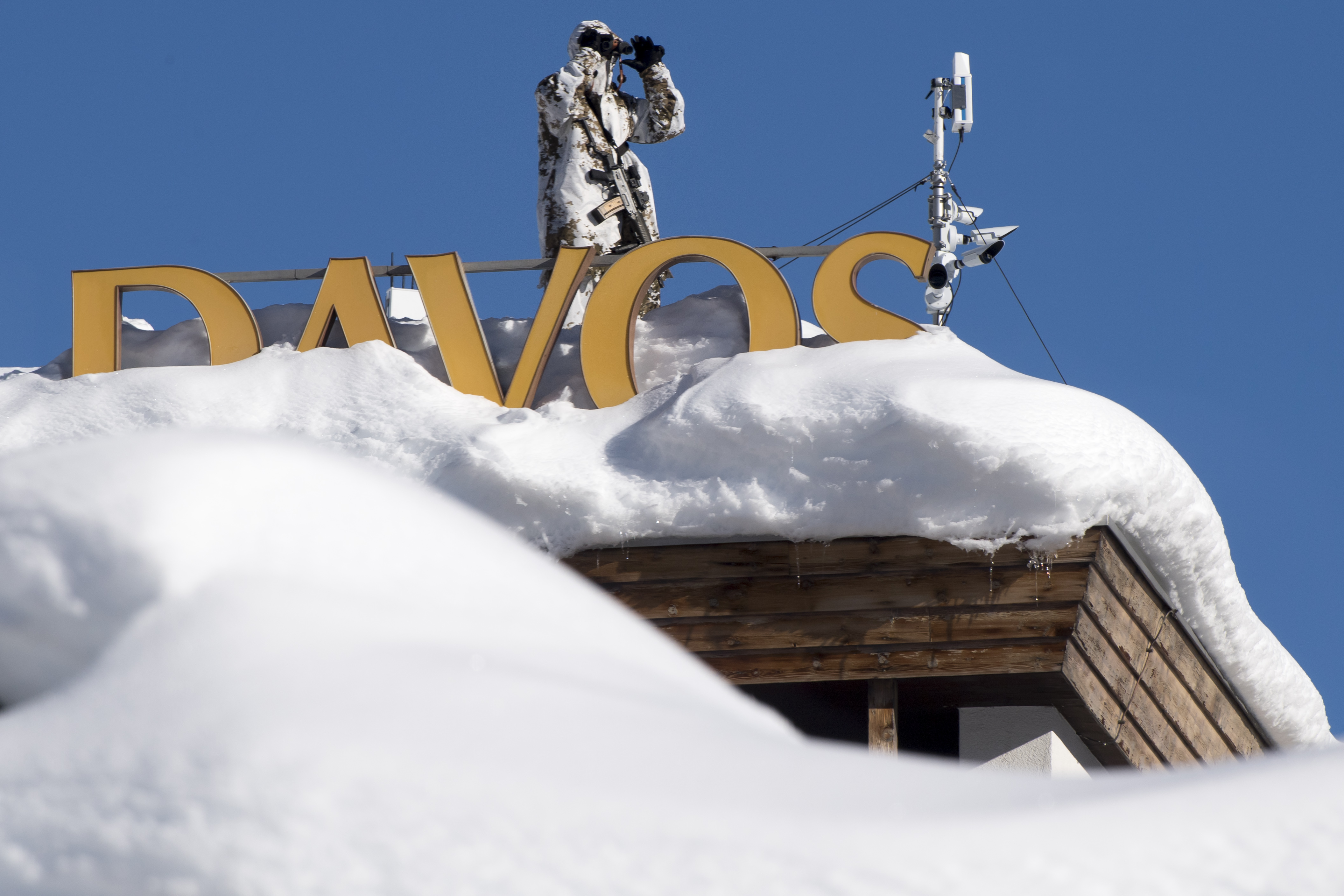 Member of Swiss special police forces stand on the roof of the Kongress Hotel next to the Congress Center the first day of the 49th Annual Meeting of the World Economic Forum, WEF, in Davos, Switzerland, Tuesday, Jan. 22, 2019.  (Laurent Gillieron/Keystone via AP)