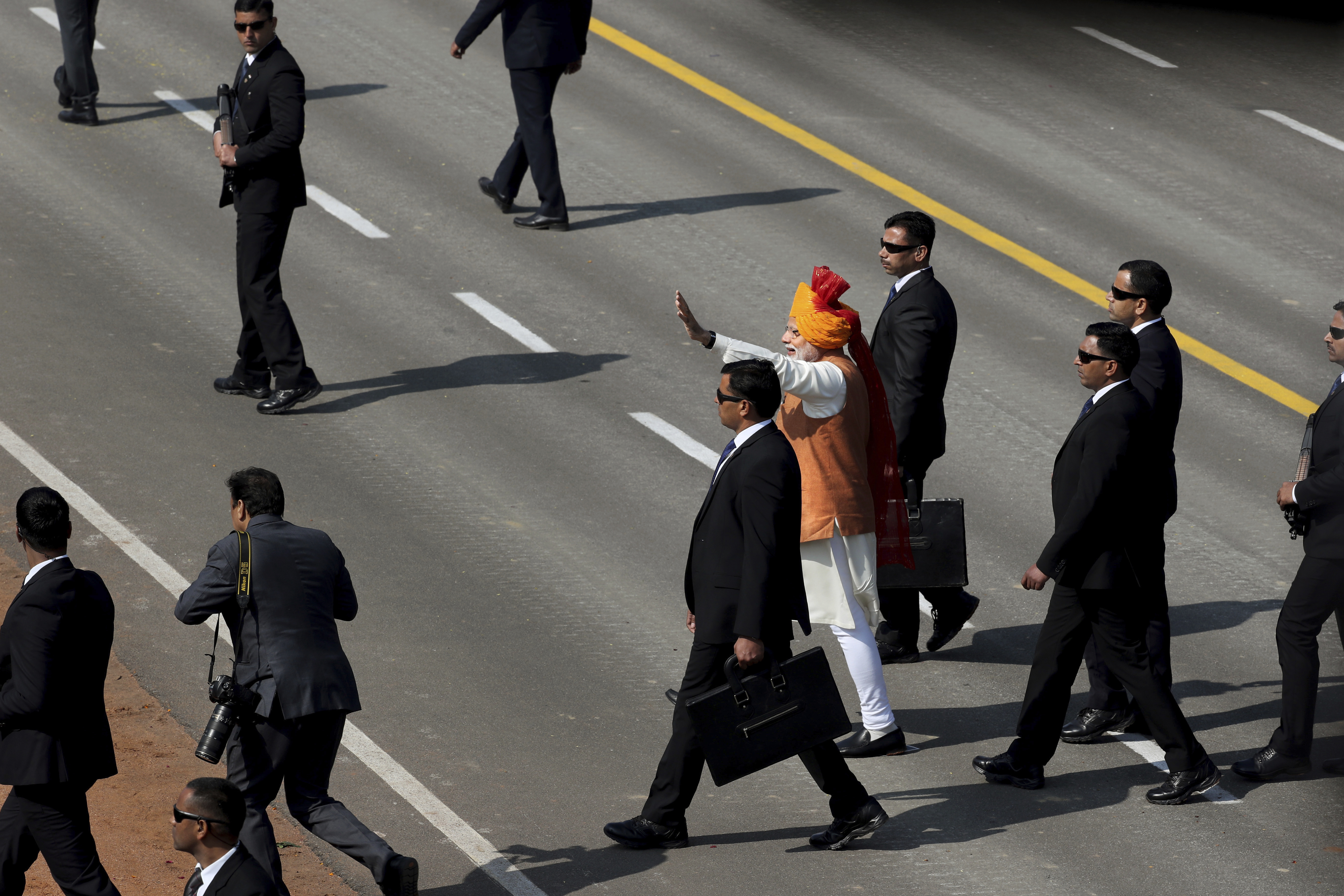 Indian Prime Minister Narendra Modi, center, waves to the crowd on Rajpath, the ceremonial boulevard, at the end of the Republic Day parade in New Delhi, India, Saturday, Jan. 26, 2019. Thousands of Indians have converged on a ceremonial boulevard to watch a display of the country's military power and cultural diversity amid tight security during national day celebrations. (AP Photo/Manish Swarup)