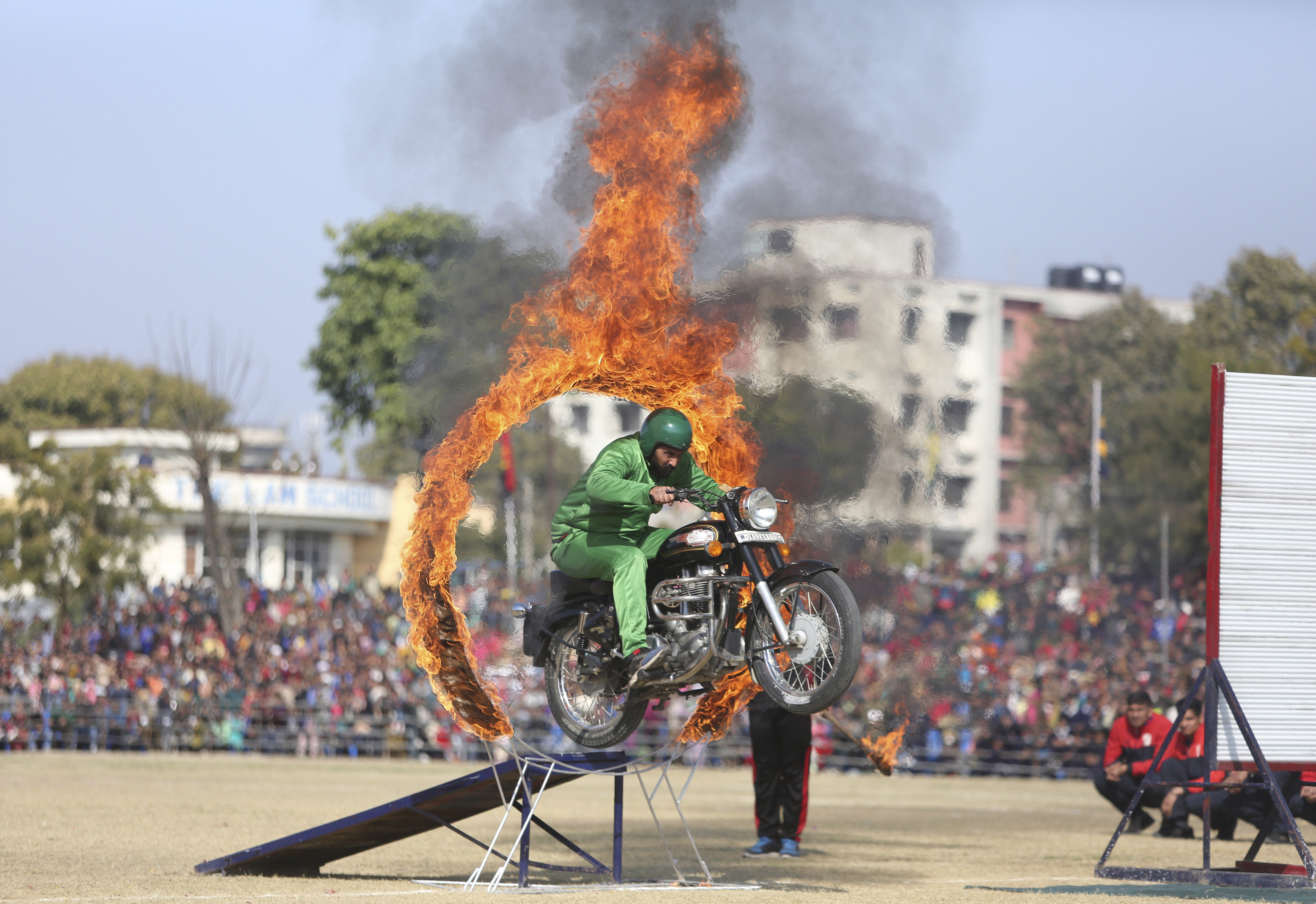A Jammu and Kashmir state policeman performs a motorcycle stunt during Republic Day celebrations in Jammu, India, Saturday, Jan. 26, 2019. (AP Photo/Channi Anand)