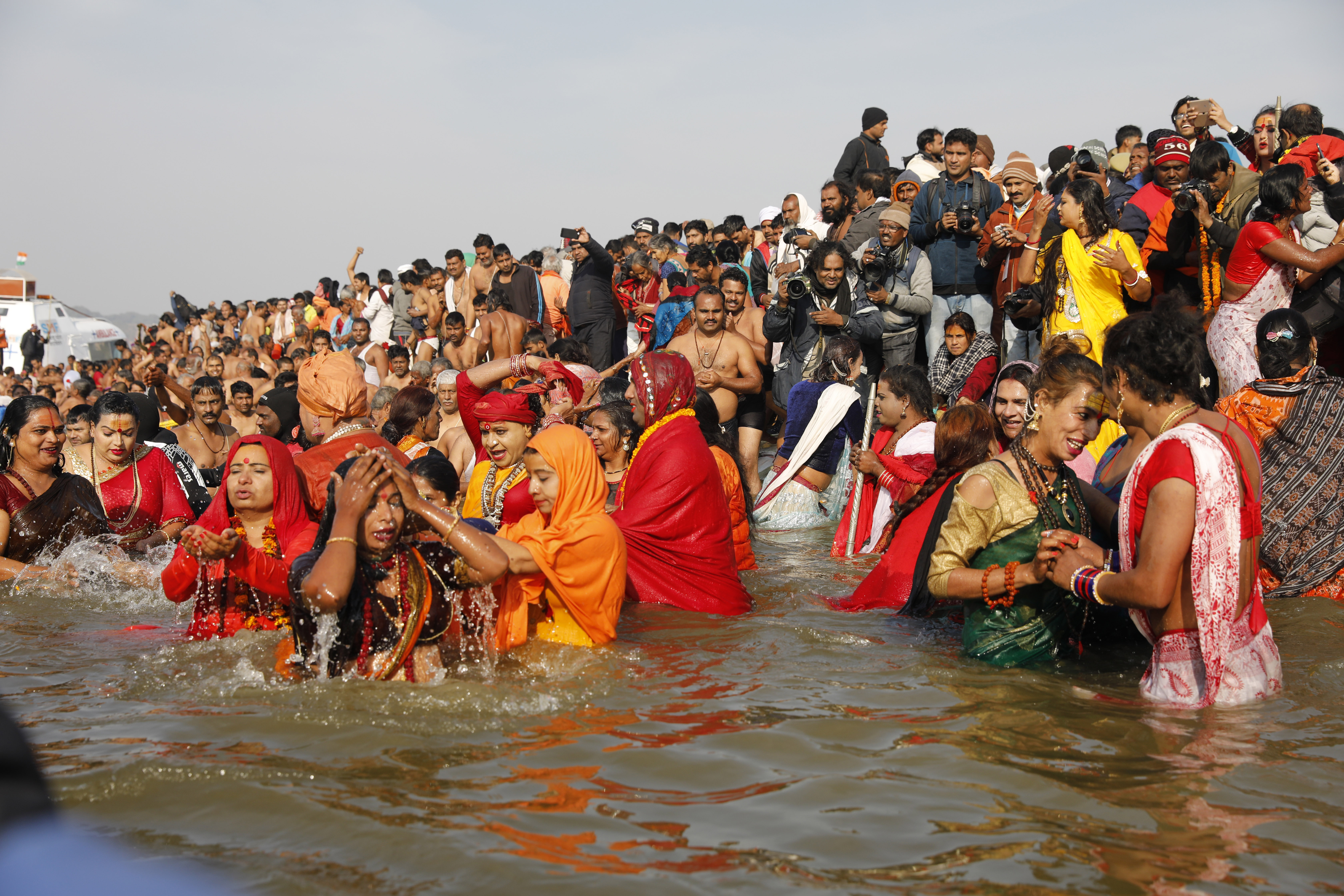 Members of Kinnar Akhara for transgenders take ritualistic dips on the auspicious Makar Sankranti day during the Kumbh Mela, or pitcher festival, in Prayagraj, Uttar Pradesh state, India, Tuesday, Jan. 15, 2019. The Kumbh Mela is a series of ritual baths by Hindu holy men, and other pilgrims at the confluence of three sacred rivers — the Yamuna, the Ganges and the mythical Saraswati — that dates back to at least medieval times. The city's Mughal-era name Allahabad was recently changed to Prayagraj. (AP Photo/Rajesh Kumar Singh)