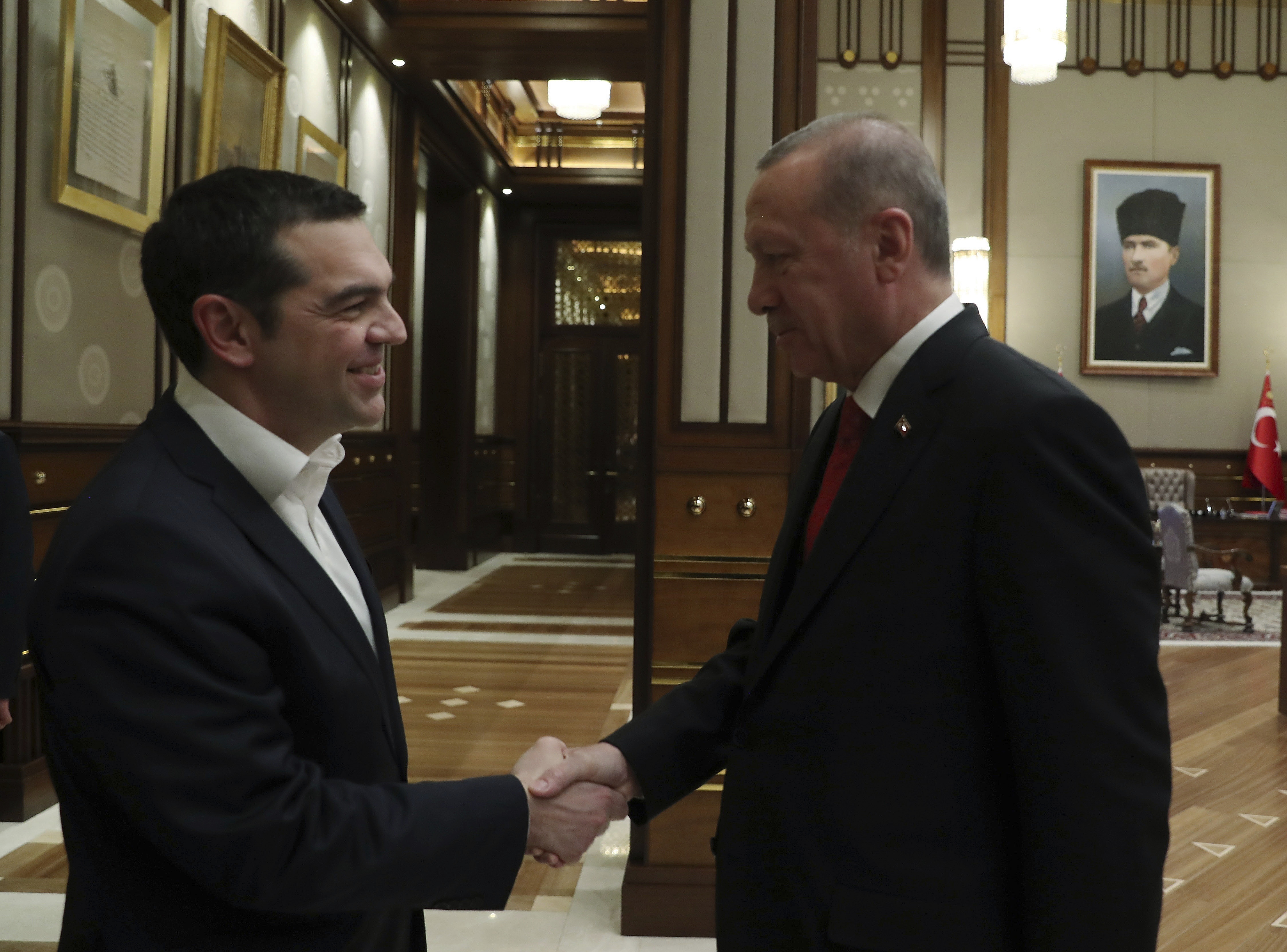 Turkey's President Recep Tayyip Erdogan, right, shakes hands with Greece's Prime Minister Alexis Tsipras during their meeting in Ankara, Tuesday, Feb. 5, 2019. A two-day visit by Greek Prime Minister Alexis Tsipras to Turkey got off to a shaky start Tuesday after Turkey put up bounties for the capture of eight Turkish servicemen who fled to Greece following a failed coup in 2016. (Presidential Press Service via AP, Pool)