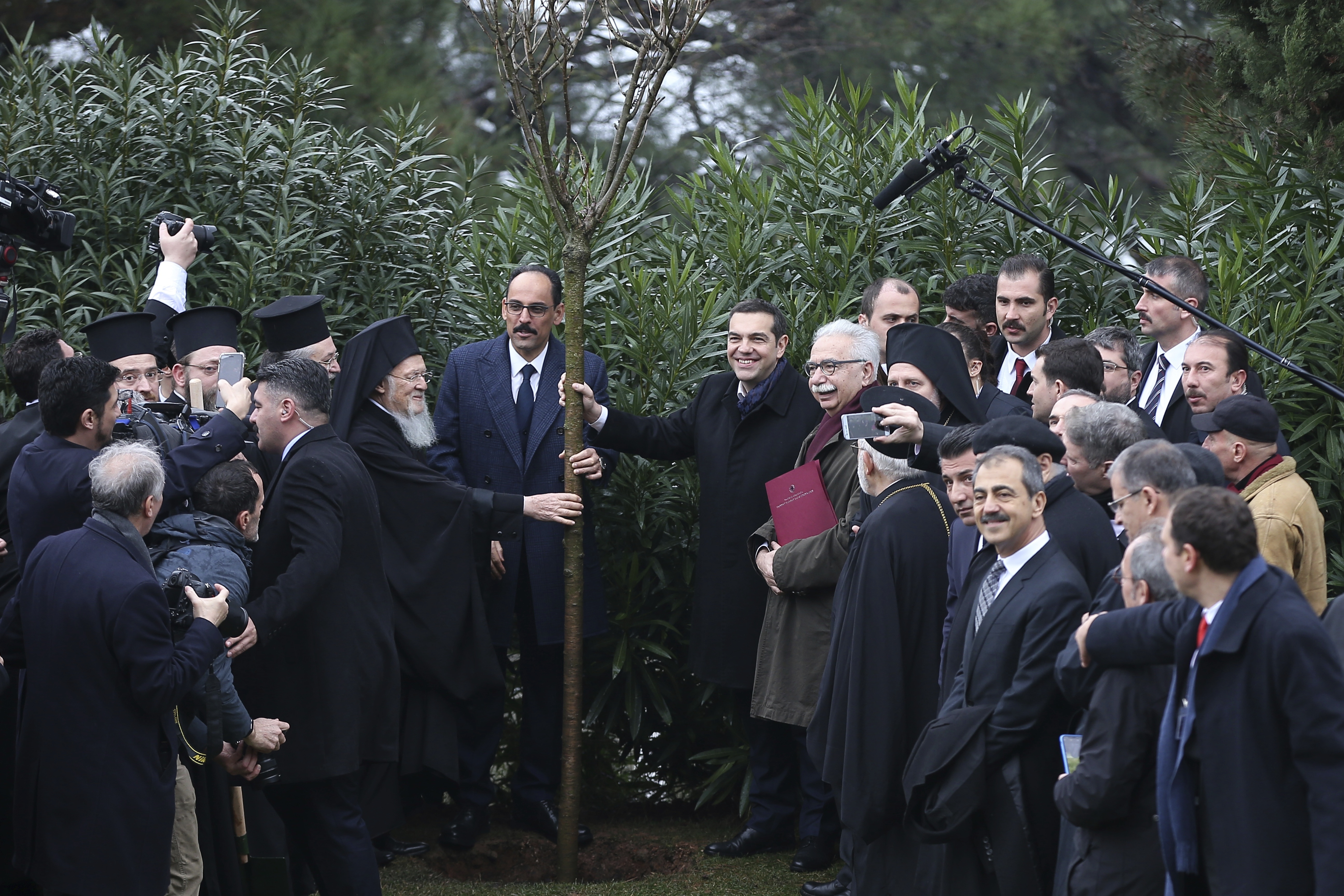 Greece's Prime Minister Alexis Tsipras, right, and Ecumenical Patriarch Bartholomew I, left, hold a tree during their visit at the Theological School of Halki, in Heybeli Island, near Istanbul, Wednesday, Feb. 6, 2019. The president of Turkey and the prime minister of Greece agreed Tuesday on the need to keep 