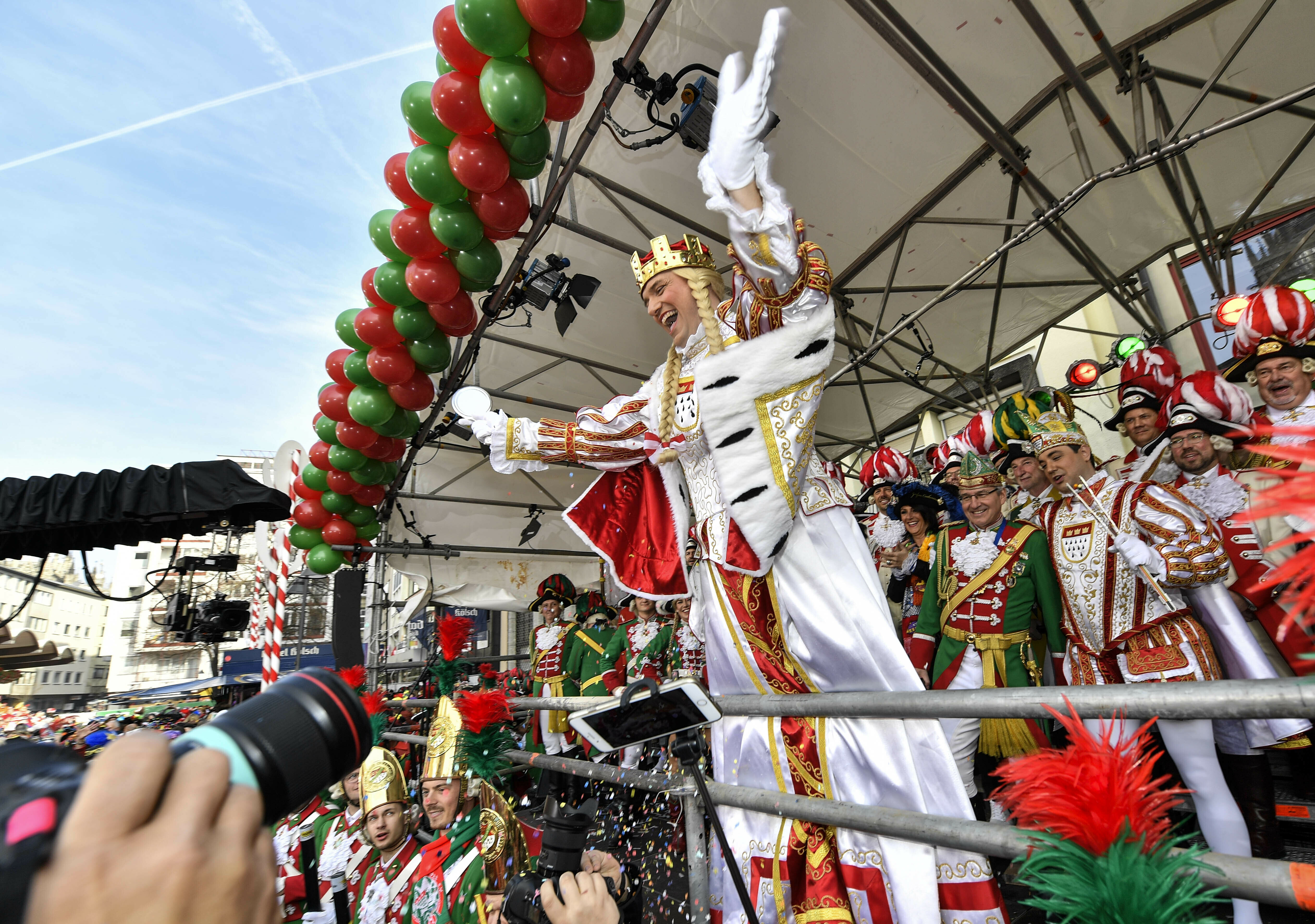 The traditional carnival virgin waves from a podium when thousands of revelers dressed in carnival costumes celebrate the start of the street carnival in Cologne, Germany, Thursday, Feb. 28, 2019. (AP Photo/Martin Meissner)