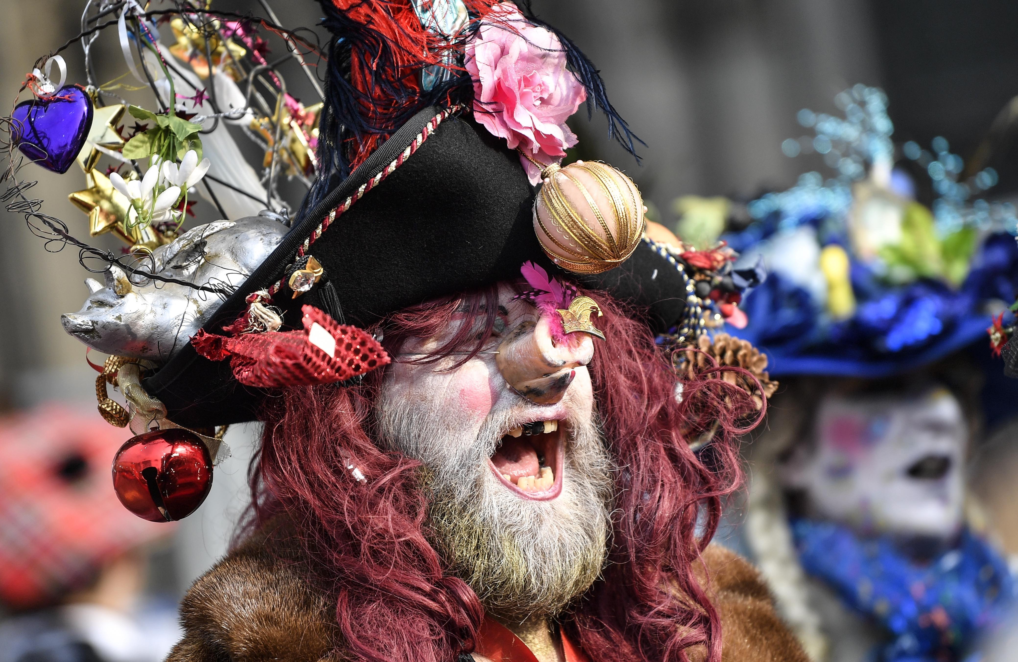 A man in pirate costume sings in Cologne's city center when thousands of revelers in carnival costumes celebrate the start of the street carnival in Cologne, Germany, Thursday, Feb. 28, 2019. (AP Photo/Martin Meissner)