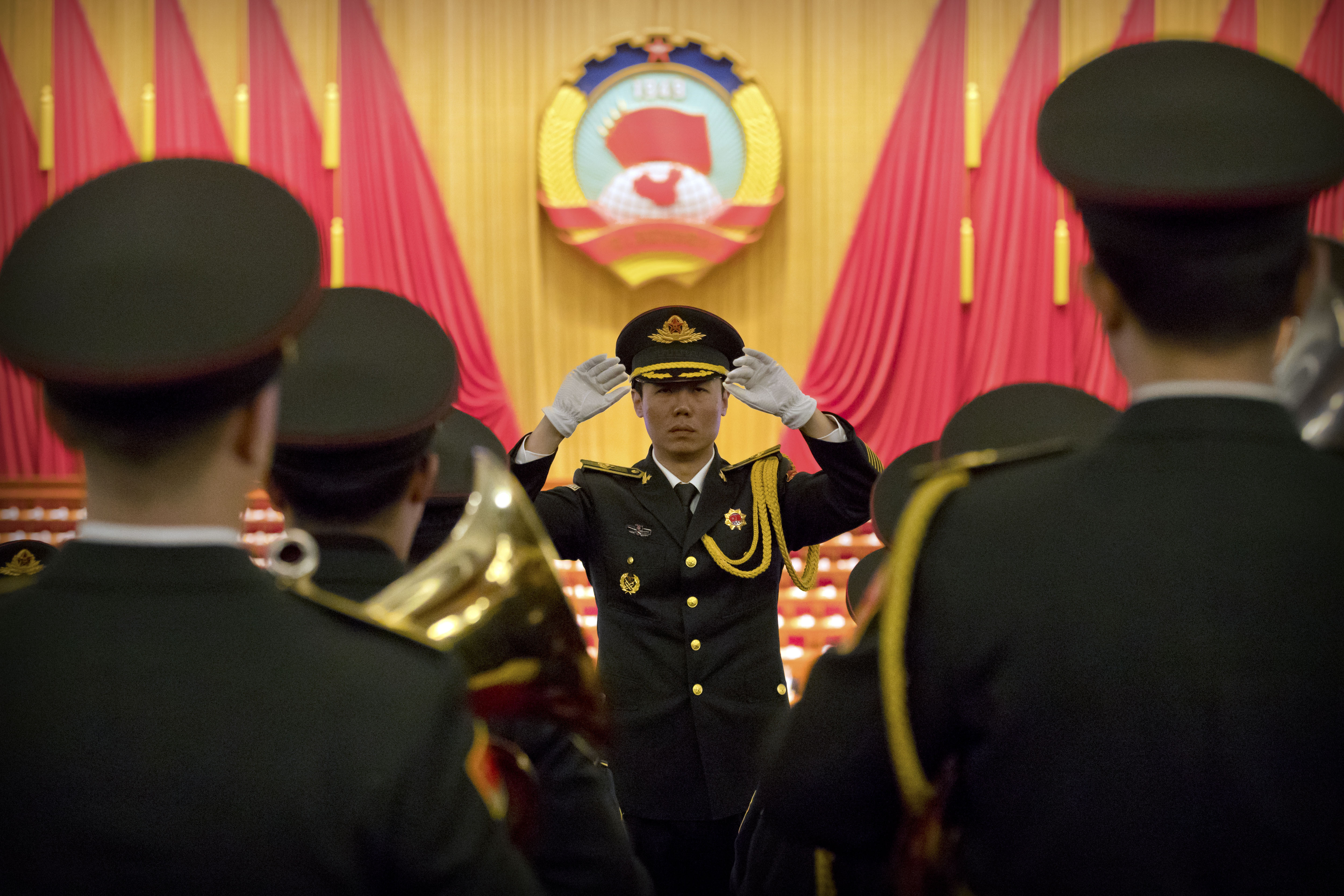 A Chinese military conductor gestures as he instructs his music band members during a rehearsal before the closing session of the Chinese People's Political Consultative Conference (CPPCC) at the Great Hall of the People in Beijing, Wednesday, March 13, 2019. (AP Photo/Mark Schiefelbein)