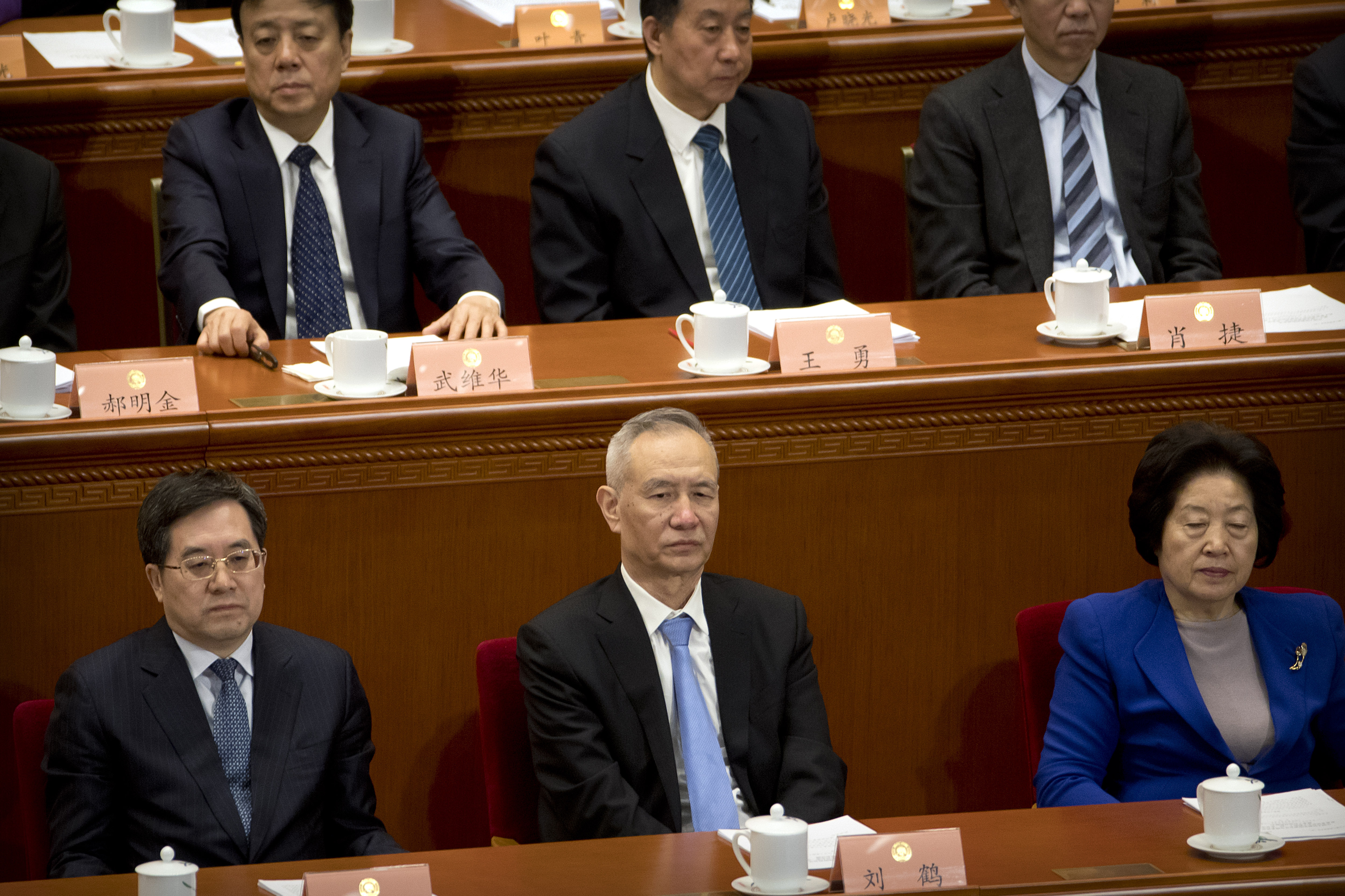 Chinese Vice Premier Liu He, bottom center, attends the closing session of the Chinese People's Political Consultative Conference (CPPCC) at the Great Hall of the People in Beijing, Wednesday, March 13, 2019. (AP Photo/Mark Schiefelbein)