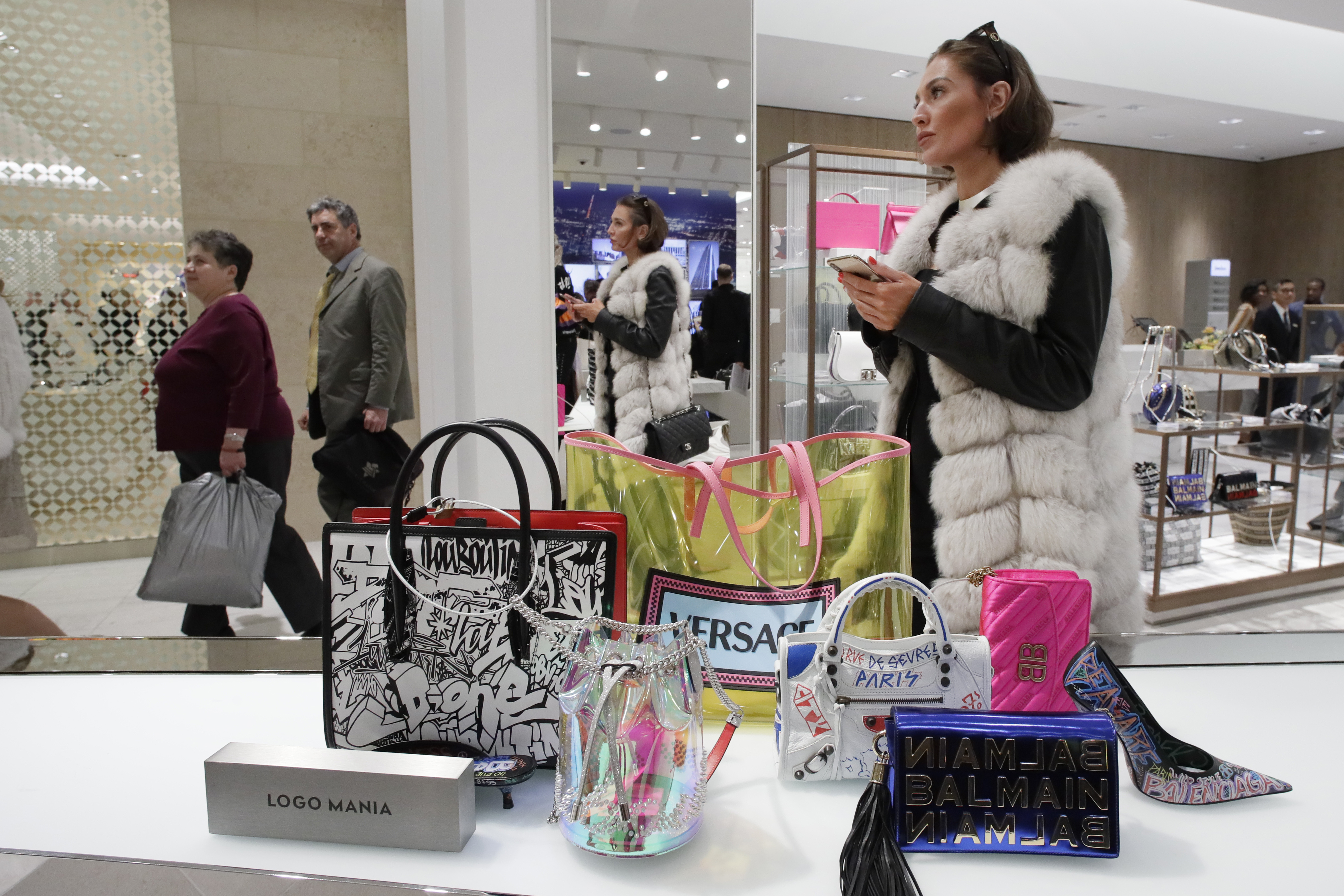 A woman shops at Neiman Marcus during the opening night of The Shops & Restaurants at Hudson Yards, Thursday, March 14, 2019, in New York. Hudson Yards, a $25 billion urban complex on Manhattan's west side, is the city's most ambitious development since the rebuilding of the World Trade Center. When fully complete, the 28-acre site will include 16 towers of homes and offices, a hotel, a school, the highest outdoor observation deck in the Western Hemisphere, a performing arts center and the shopping mall. (AP Photo/Mark Lennihan)