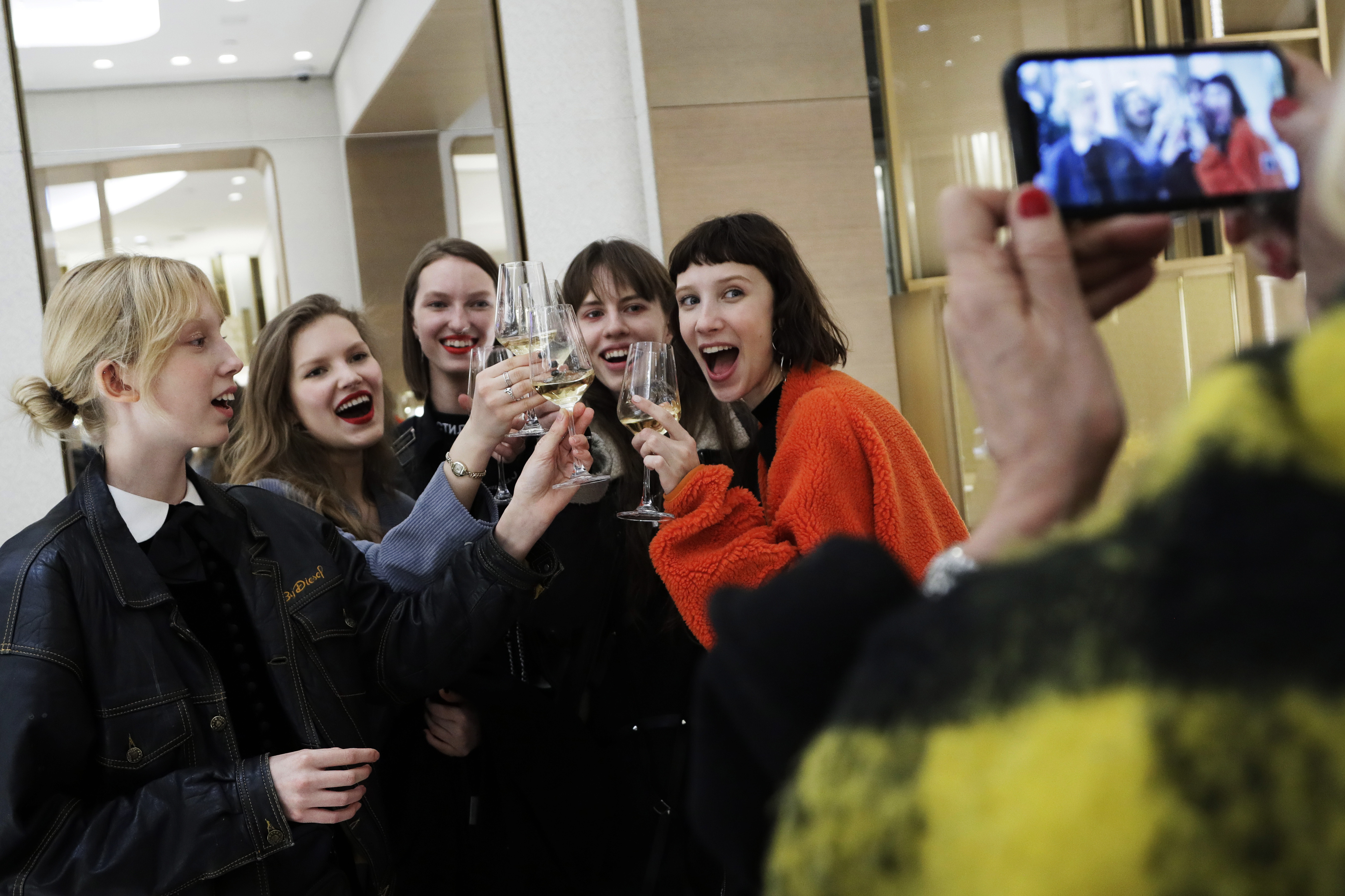 Women celebrate at a Cartier store during the opening night of The Shops & Restaurants at Hudson Yards, Thursday, March 14, 2019, in New York. Hudson Yards, a $25 billion urban complex on Manhattan's west side, is the city's most ambitious development since the rebuilding of the World Trade Center. When fully complete, the 28-acre site will include 16 towers of homes and offices, a hotel, a school, the highest outdoor observation deck in the Western Hemisphere, a performing arts center and the shopping mall. (AP Photo/Mark Lennihan)