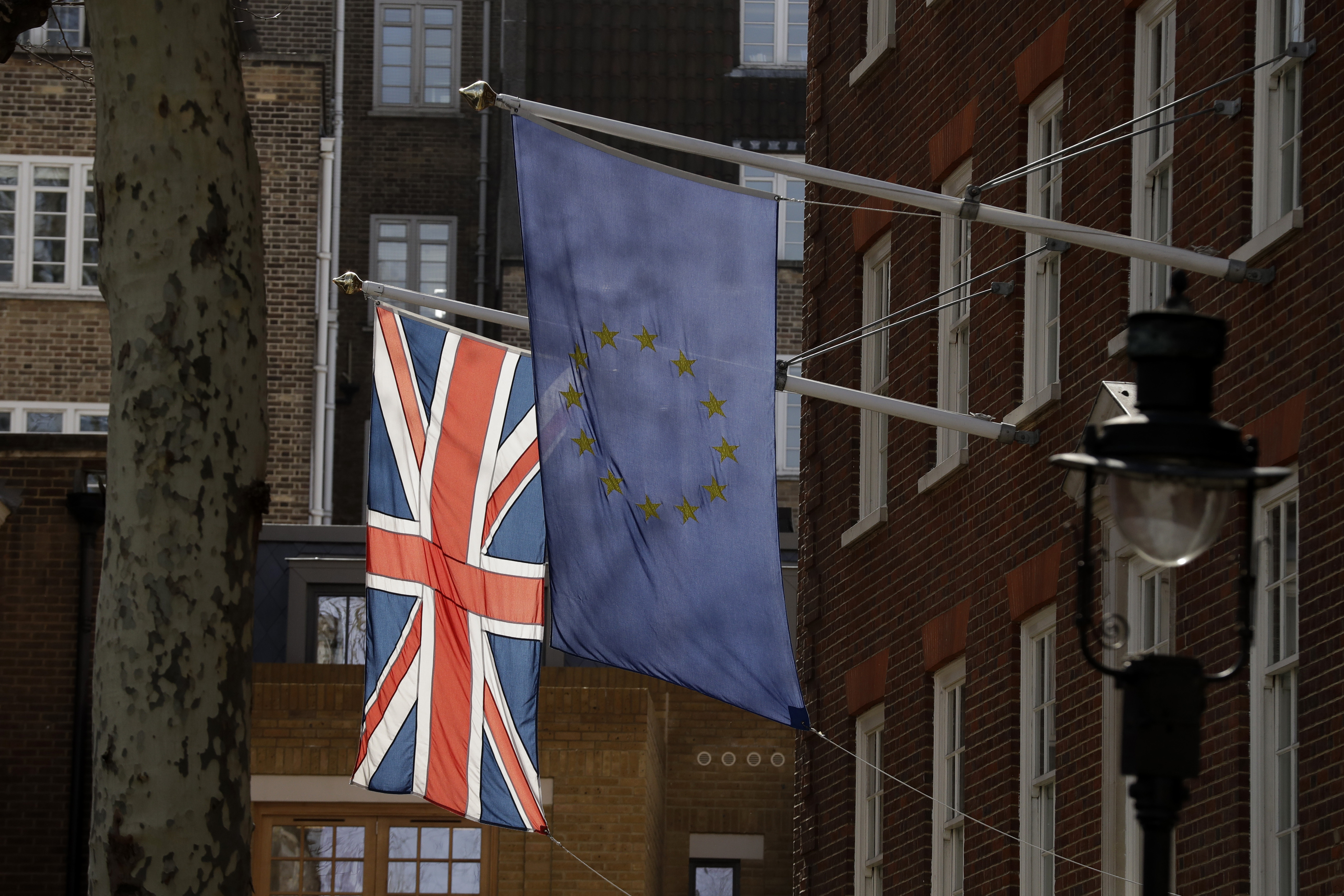 A European flag and a British Union flag hang outside Europe House, the European Parliament's British offices in London, Monday, March 18, 2019. British Prime Minister Theresa May was making a last-minute push Monday to win support for her European Union divorce deal, warning opponents that failure to approve it would mean a long — and possibly indefinite — delay to Brexit. Parliament has rejected the agreement twice, but May aims to try a third time this week if she can persuade enough lawmakers to change their minds. (AP Photo/Matt Dunham)