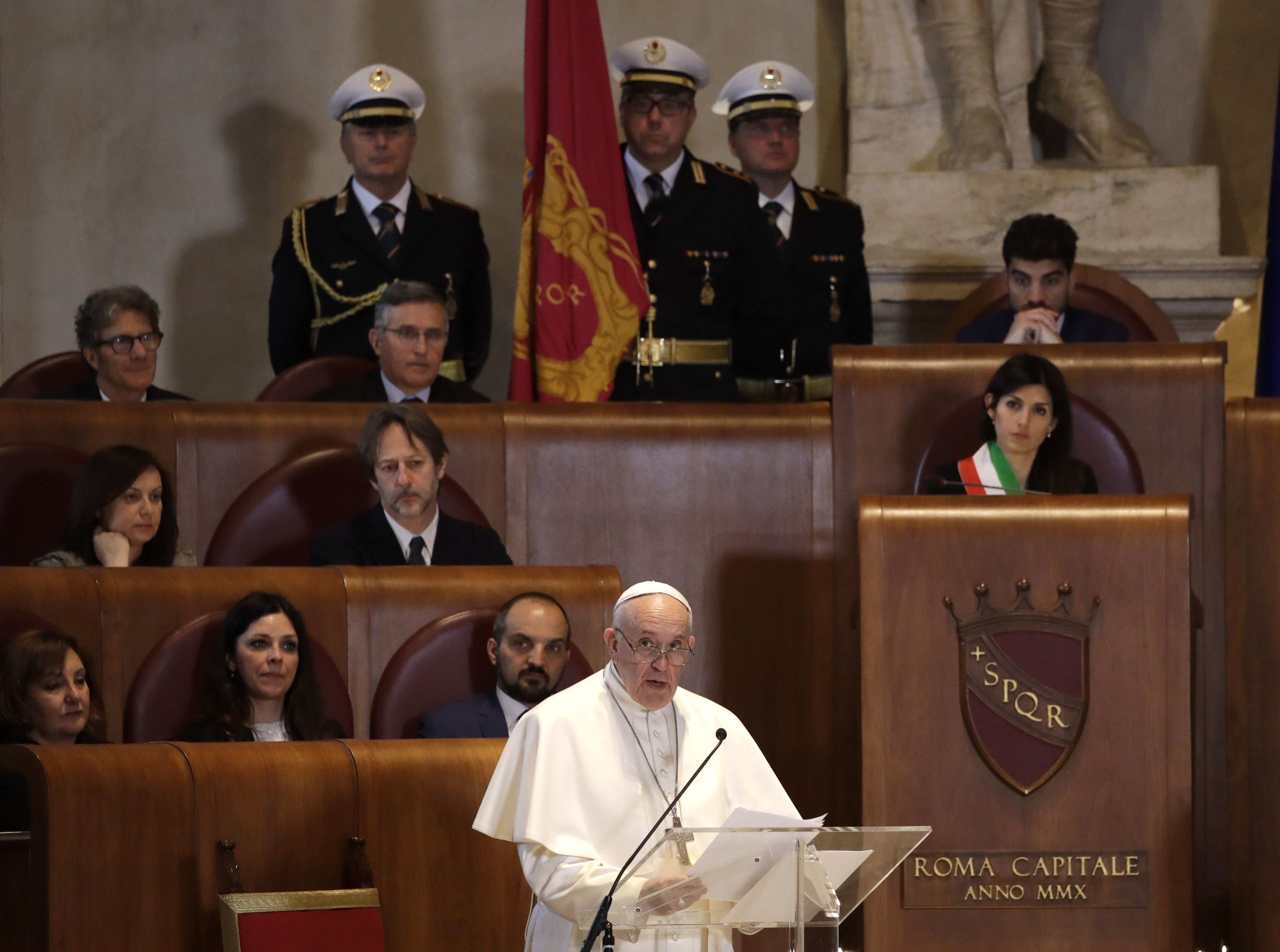Pope Francis delivers his speech in the Julius Caesar Hall as Rome's Mayor Virginia Raggi, right, listen to him during his visit to the Campidoglio, Capitol Hill, in Rome, Tuesday, March 26, 2019. (AP Photo/Alessandra Tarantino)