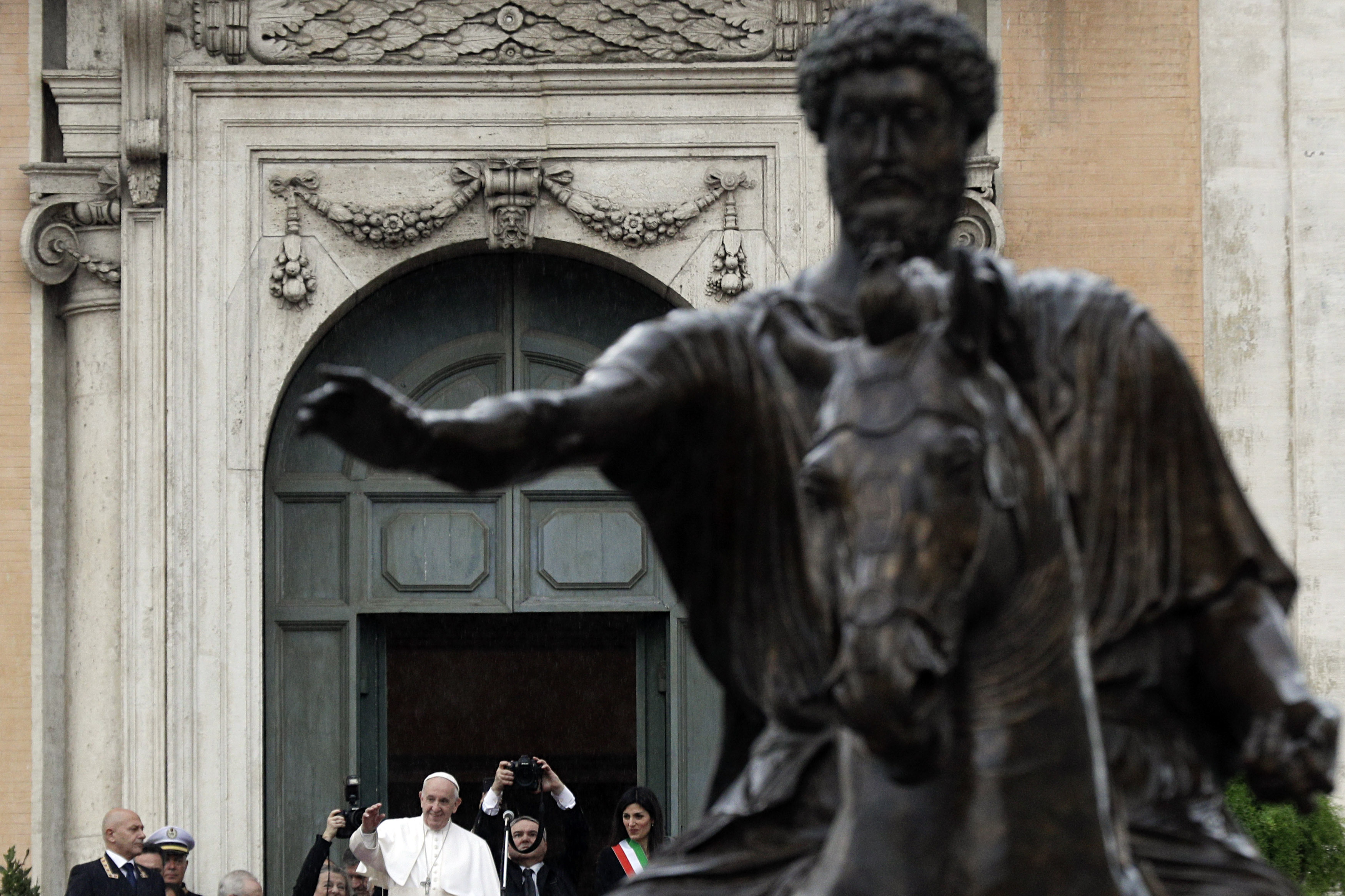 Pope Francis, framed by the bronze equestrian statue of Marcus Aurelius, delivers his speech during his visit at the Campidoglio, Capitol hill, in Rome, Tuesday, March 26, 2019. (AP Photo/Gregorio Borgia)
