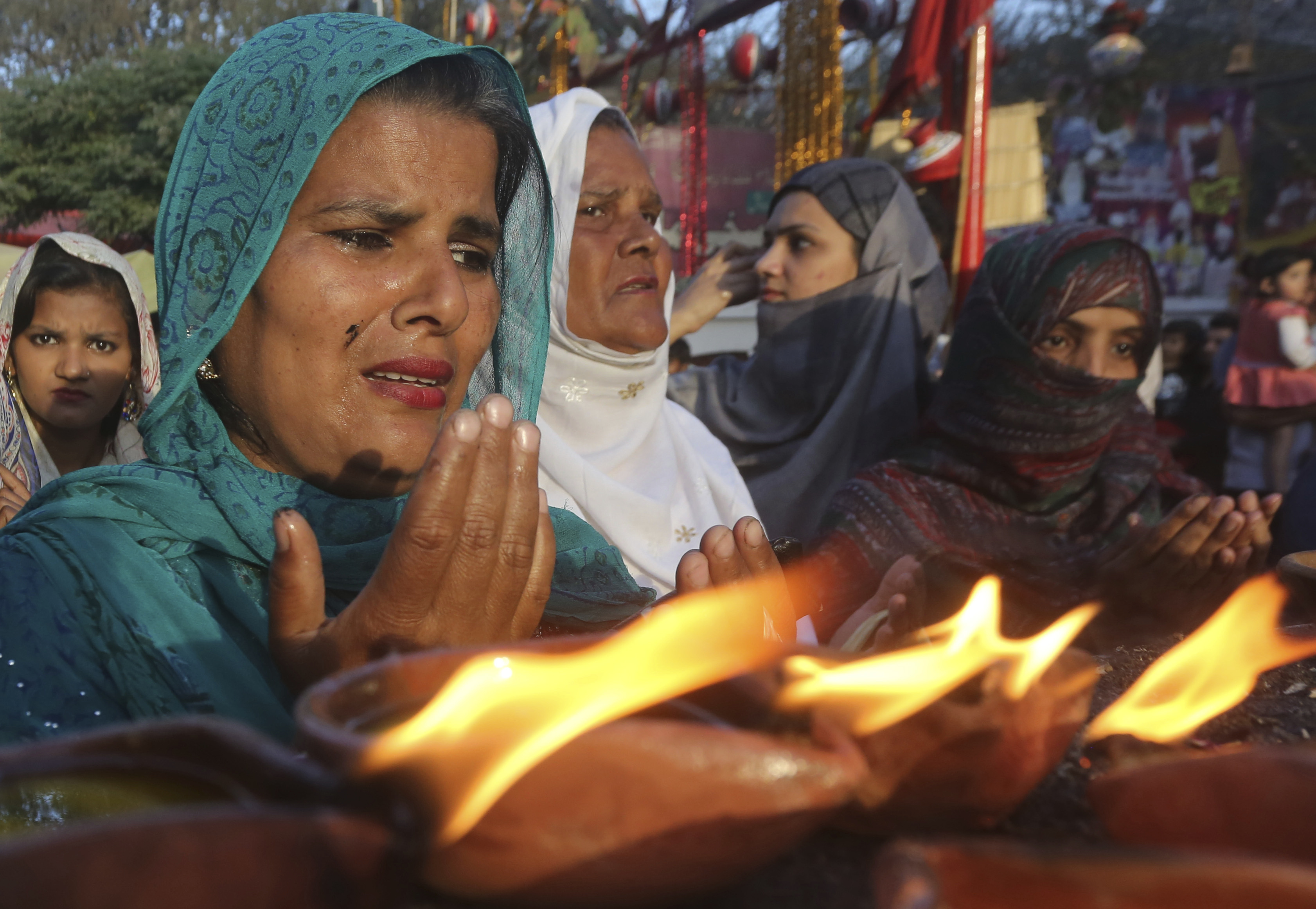 Pakistani pilgrims pray at the shrine of Madhu Lal Shah Hussain, a poet also regarded as a Sufi saint, during an annual festival to celebrate him in Lahore, Pakistan, Monday, April 1, 2019. The annual festival to commemorate Shah Hussain (1538-1599) started with thousands of people expected to visit the shrine. (AP Photo/K.M Chaudary)