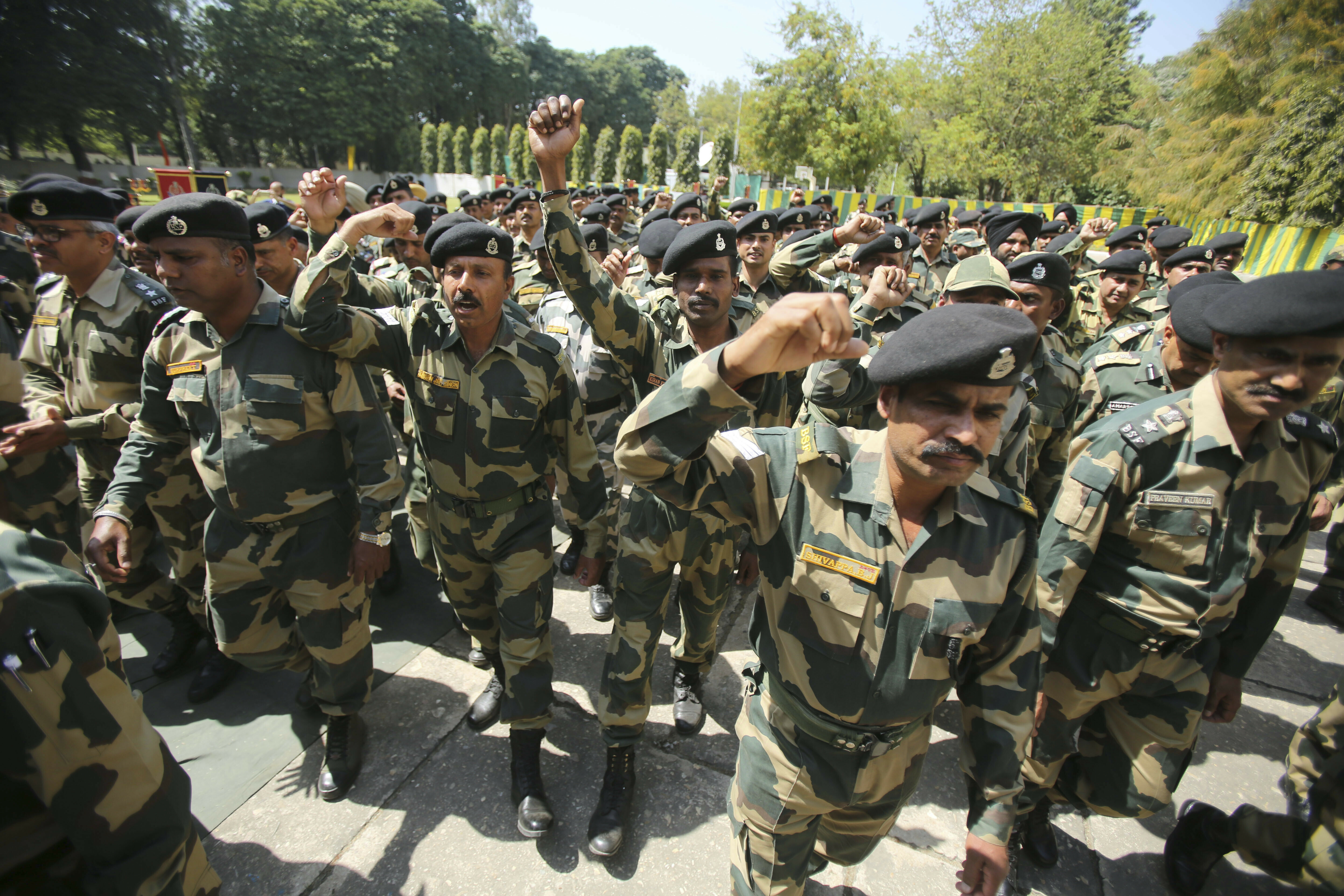 Indian Border Security Force (BSF) soldiers shout slogans as they pay tribute to to their killed colleague T. Alex Lalminlun during a wreath-laying ceremony at the BSF headquarters in Jammu, India, Tuesday, April.2, 2019.  Pakistan and India traded fire in the disputed Himalayan region of Kashmir, leaving seven people dead — three Pakistani soldiers, a Pakistani villager, an Indian woman and a girl and a member of the Indian paramilitary troops, officials said Tuesday. (AP Photo/Channi Anand)