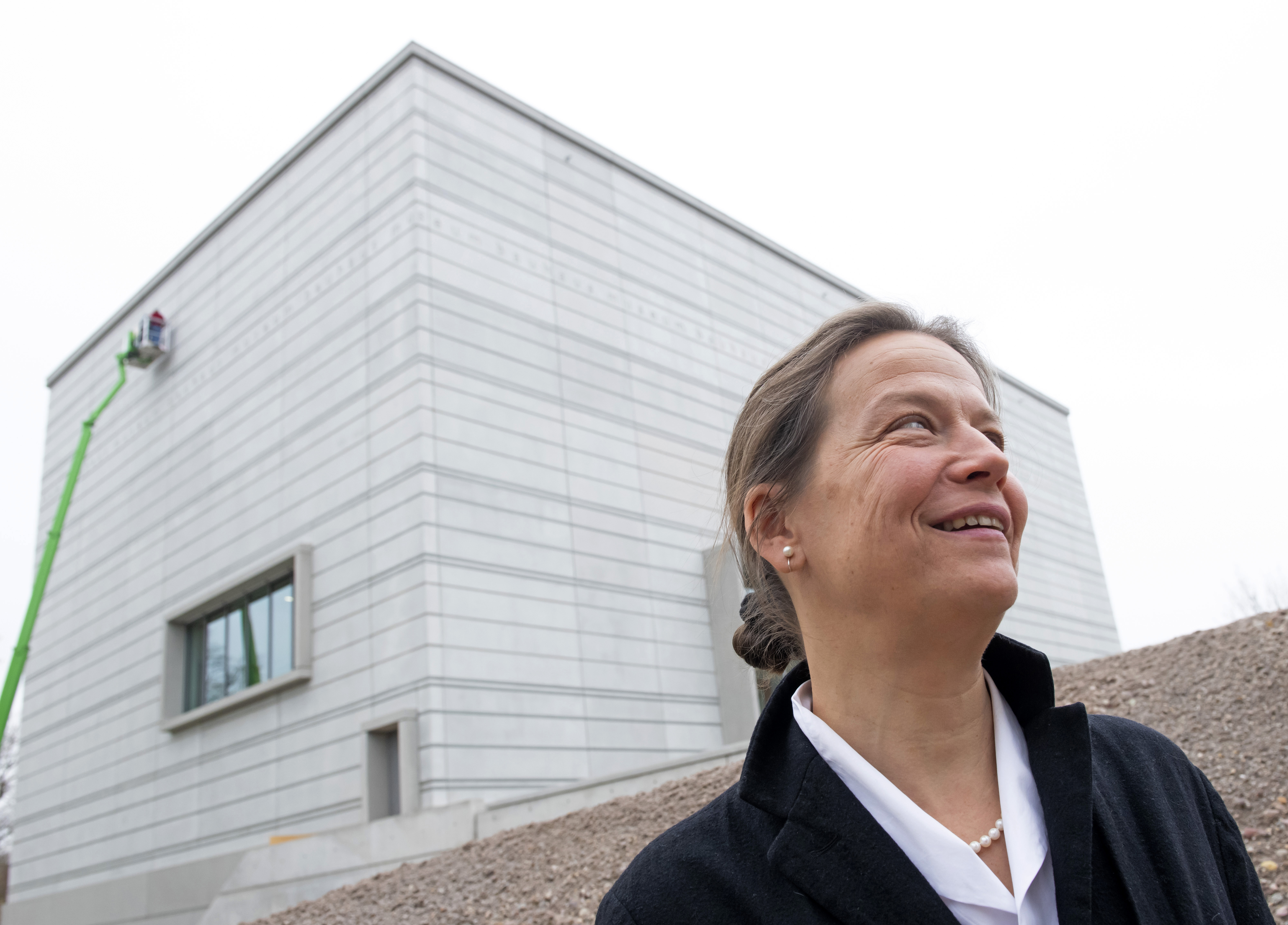 Architect Heike Hanada stands in front of the new Bauhaus Museum of the 'Klassik Stiftung Weimar' (Classic Foundation Weimar) in Weimar, Germany, Thursday, April 4, 2019. The museum designed by Berlin-based architect Heike Hanada will focus on the early Bauhaus that was founded in Weimar in 1919 and stayed there until 1925. The official opening of the new Bauhaus Museums will take place on Friday, April 5, 2019. (AP Photo/Jens Meyer)