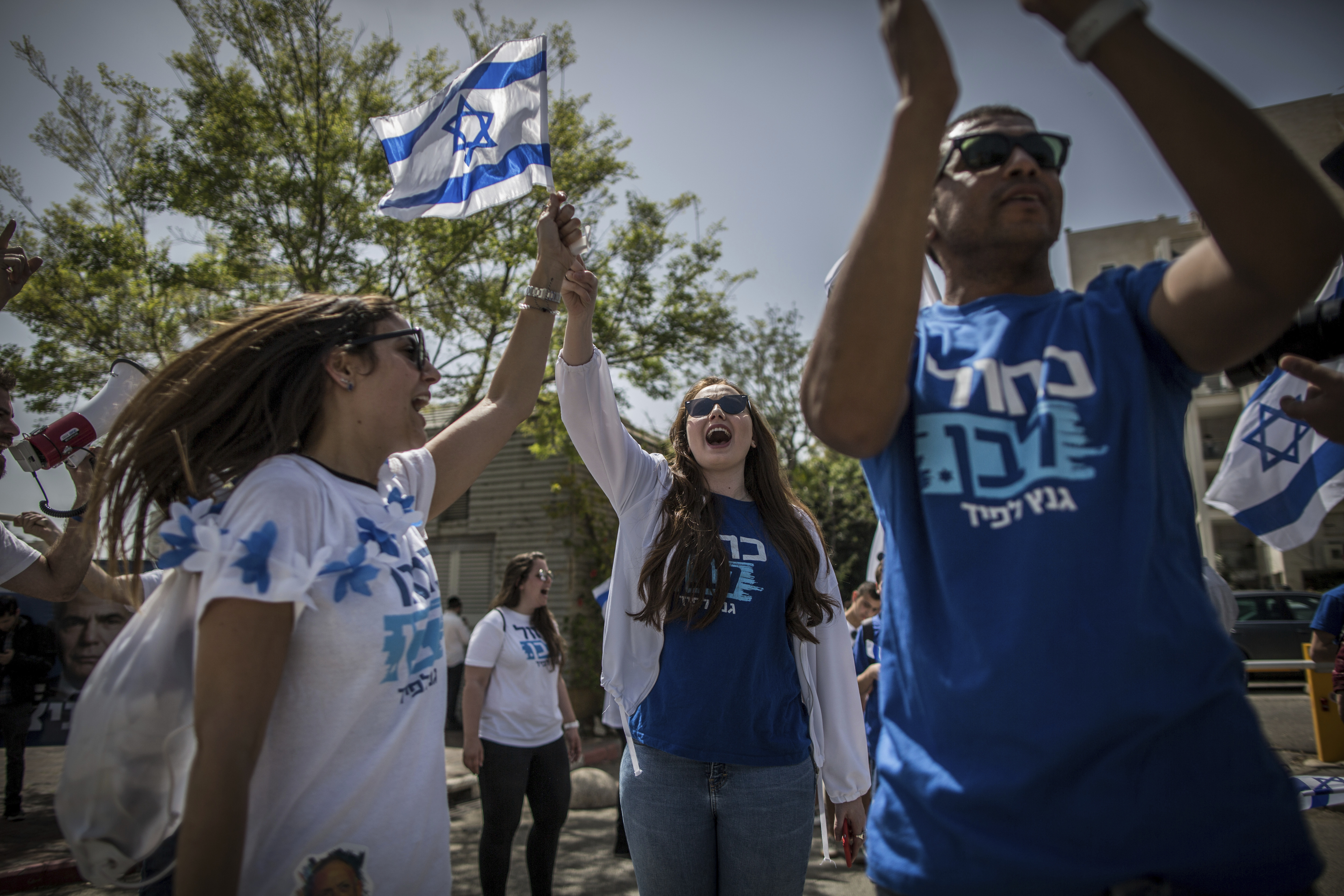 09 April 2019, Israel, Tel Aviv: Supporters of Israeli politician Benny Gantz and his Blue and White party sing and dance outside a polling station. Photo by: Oliver Weiken/picture-alliance/dpa/AP Images