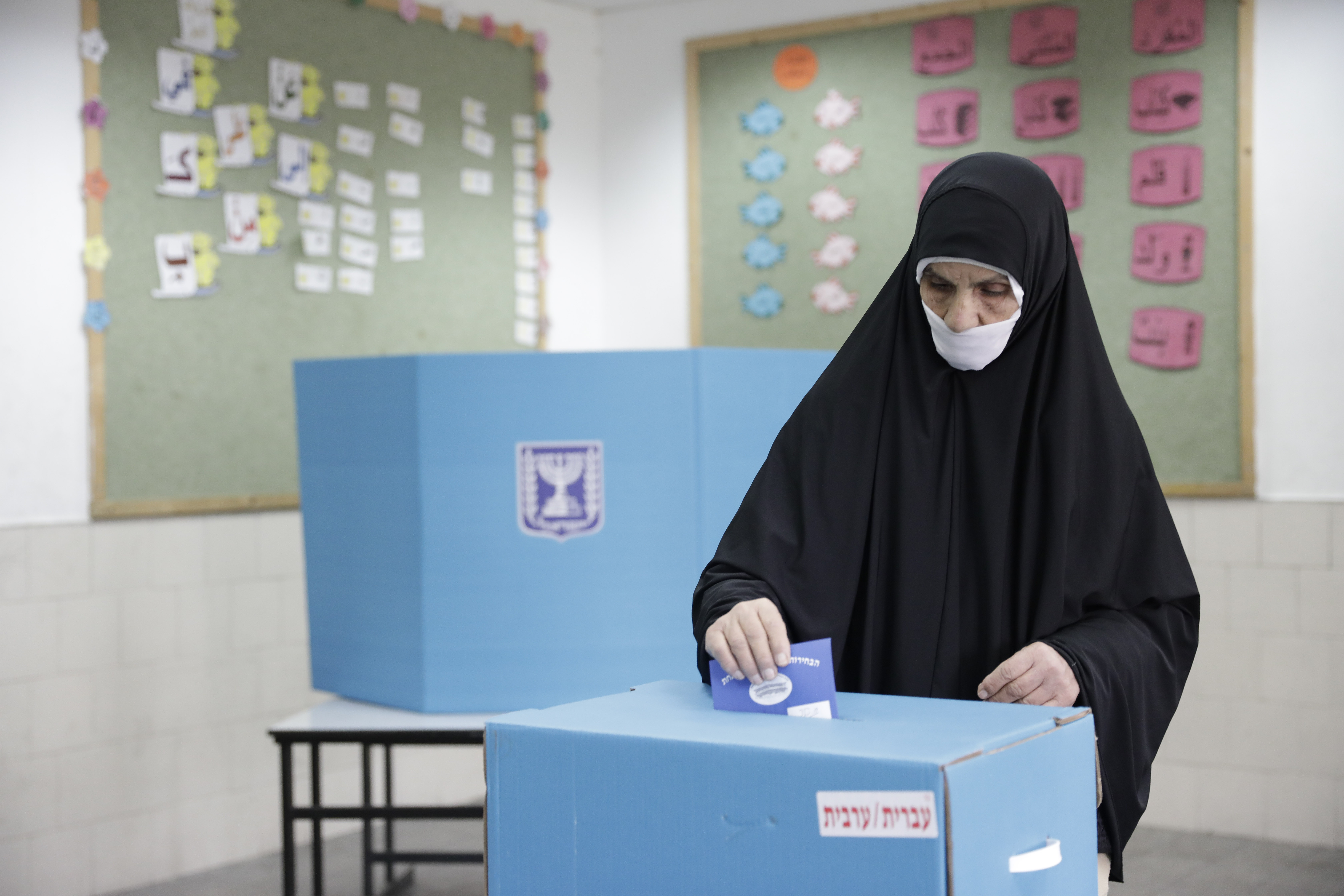 Israeli Bedouin woman votes during general elections in the city of Rahat, Tuesday, April 9, 2019. (AP Photo/Tsafrir Abayov)