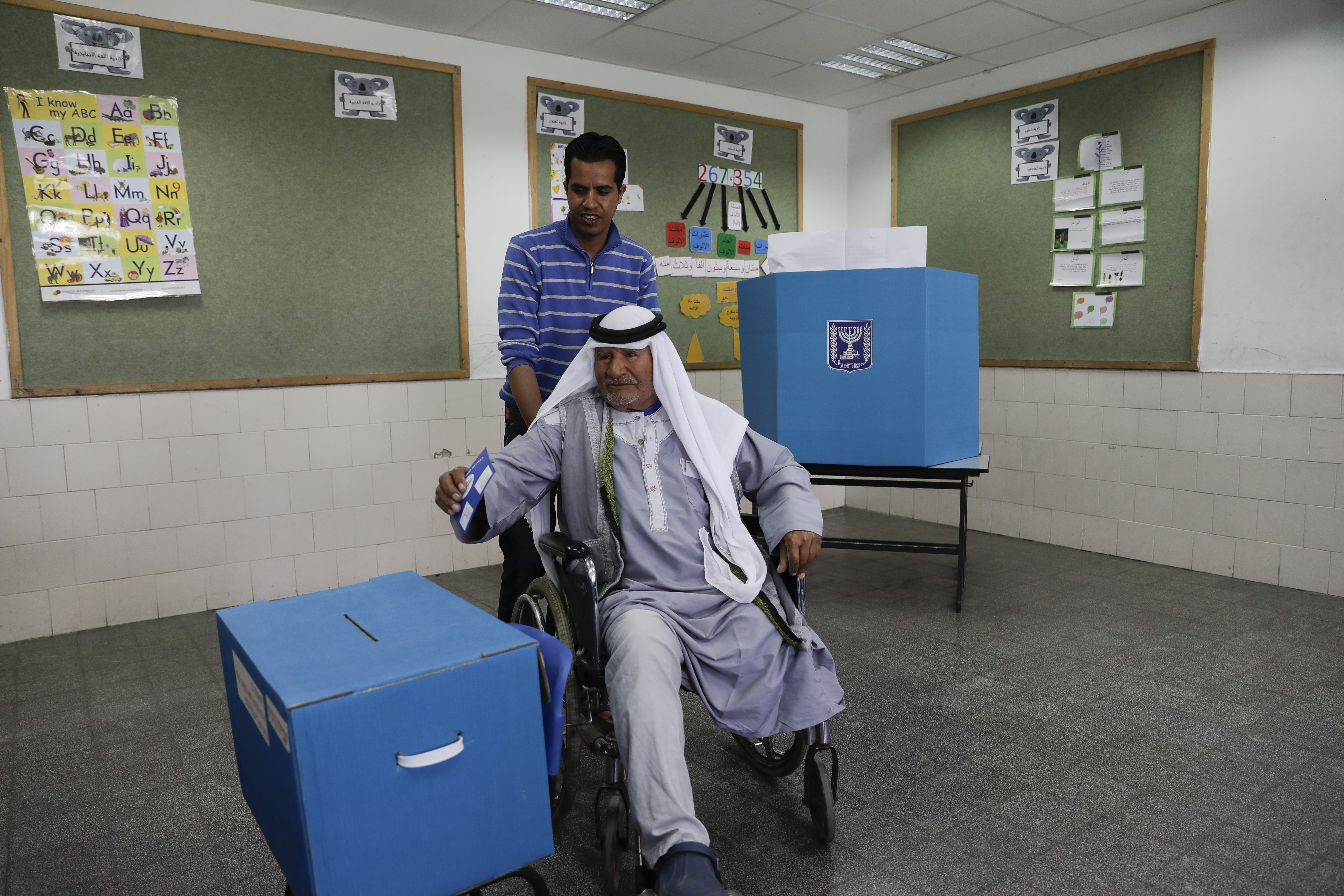 Israeli Bedouin votes during general elections in the city of Rahat, Tuesday, April 9, 2019. (AP Photo/Tsafrir Abayov)