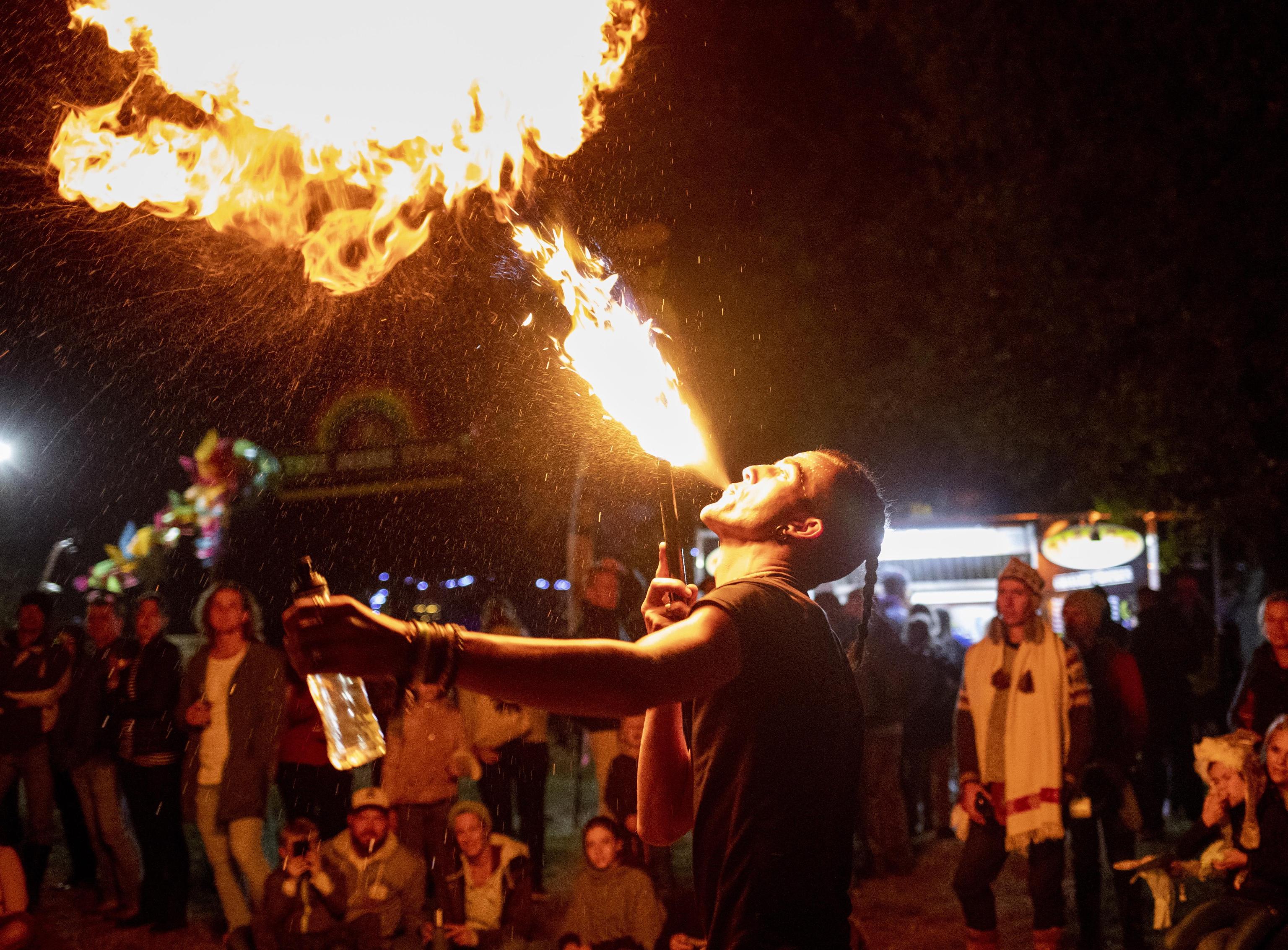epa07517001 A fire poi artist blows flames from his mouth by lighting paraffin during the annual Splashy Fen music festival, Underberg, South Africa, 19 April 2019 (issued 20 April 2019). The five day long festival is the oldest in the country and is celebrating its 30 year. The festival has four stages with various music styles, morning yoga sessions, artworks, trail running, holistic lifestyle events, stalls etc.  EPA/KIM LUDBROOK