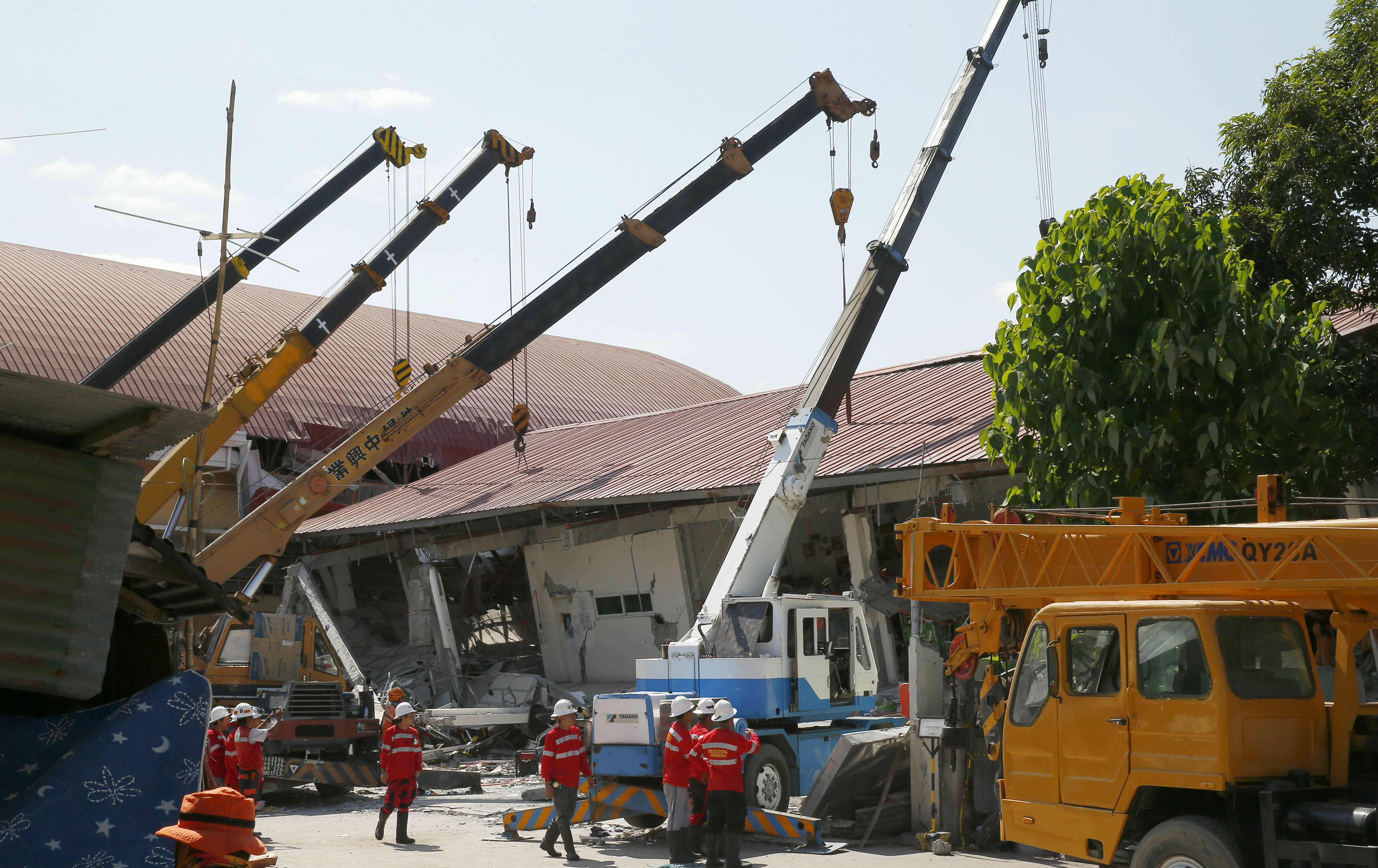 Workers fix the damage Tuesday, April 23, 2019 brought about by Monday's 6.1 magnitude earthquake that rocked Diosdado Macapagal International Airport at Clark Freeport, Pampanga province, north of Manila, Philippines. A strong earthquake struck the northern Philippines Monday trapping some people in a collapsed building, damaged an airport terminal and knocked out power in at least one province, officials said. (AP Photo/Bullit Marquez)