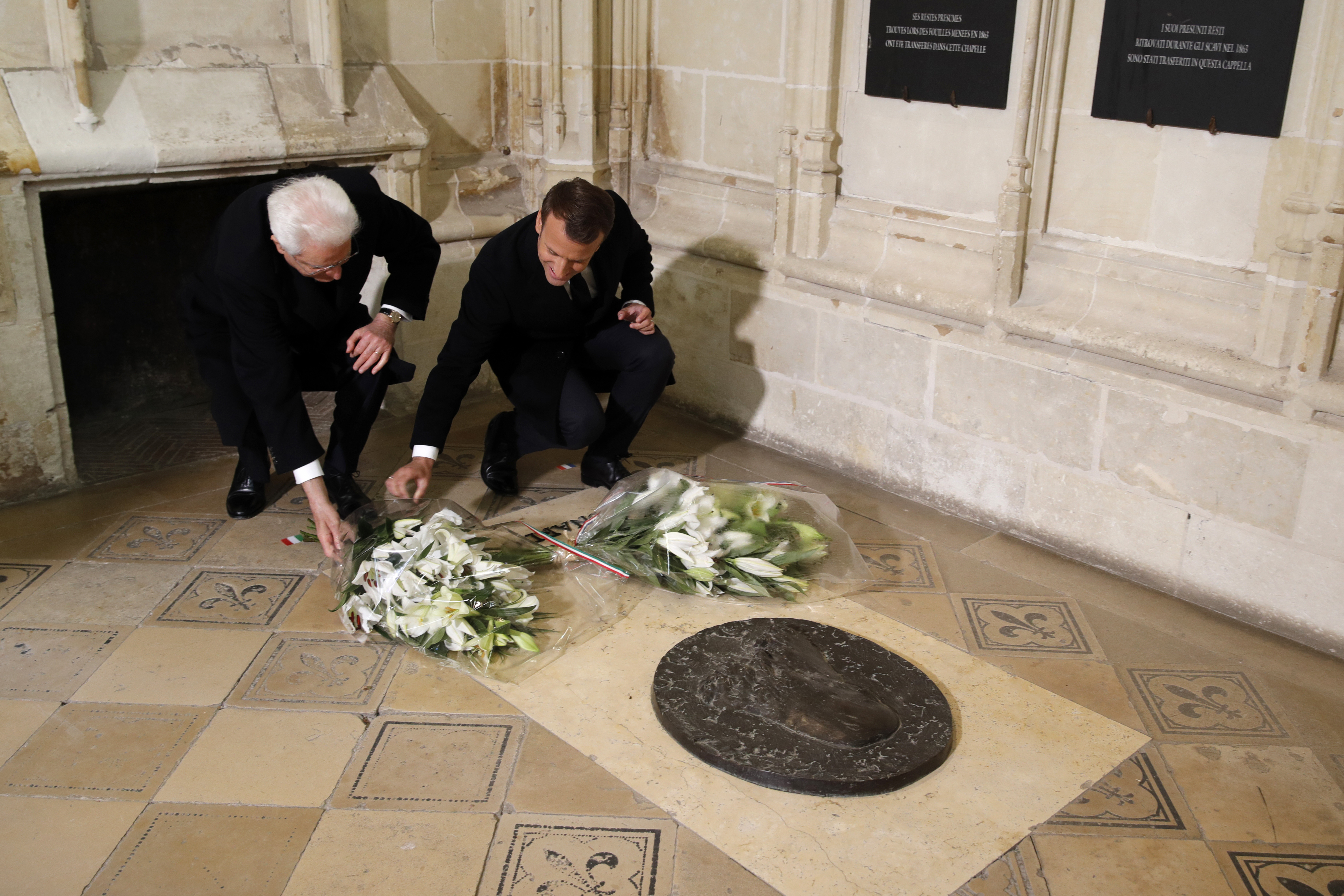 French President Emmanuel Macron and Italian President Sergio Mattarella pay their respects at the tomb of Italian renaissance painter and scientist Leonardo da Vinci to commemorate the 500th anniversary of his death, at the Saint-Hubert Chapel during a visit at the Chateau d'Amboise, in Amboise, south of Paris, France, Wednesday, May 2, 2019. (Philippe Wojazer, Pool via AP)