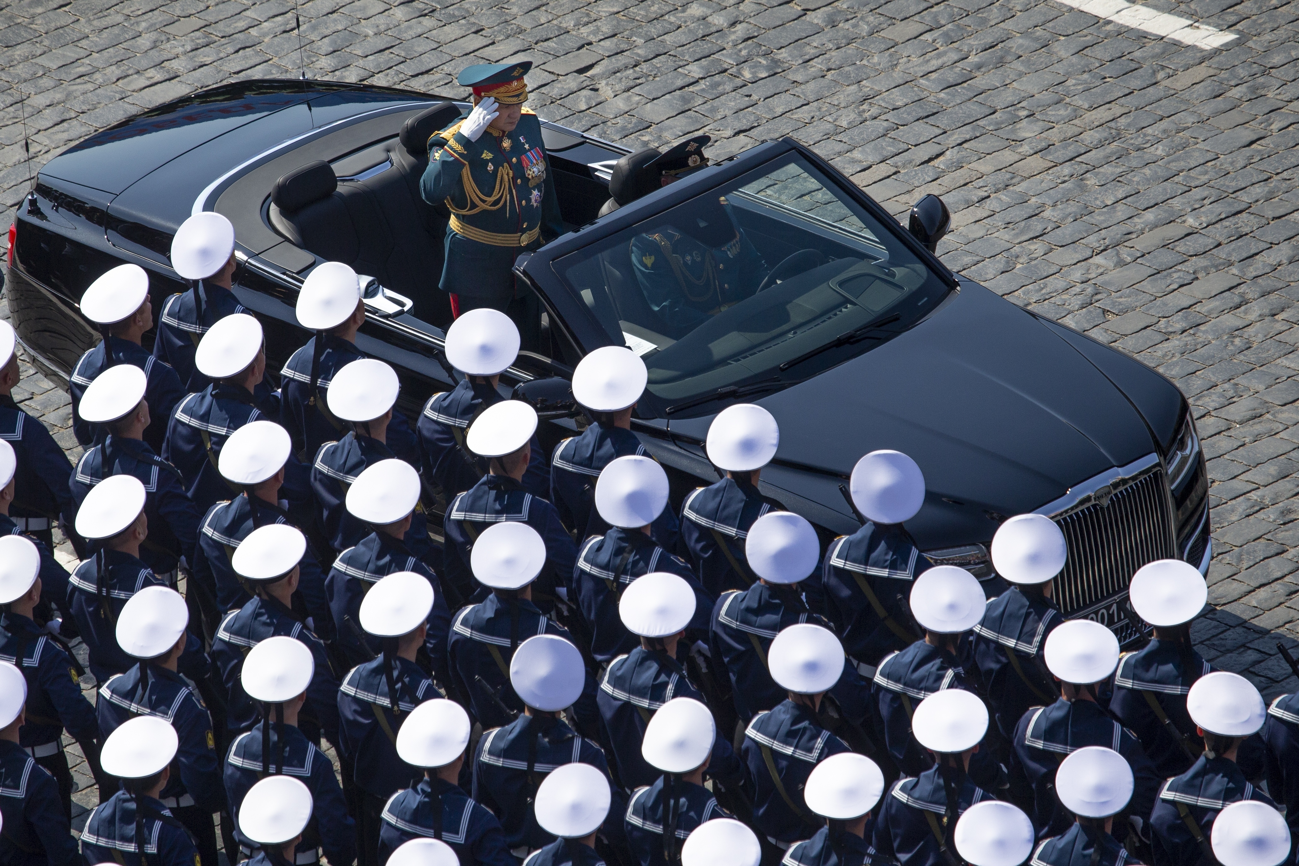 Russian Defense Minister Sergei Shoigu, top, salutes to soldiers as he is driven along Red Square during a rehearsal for the Victory Day military parade in Moscow, Russia, Tuesday, May 7, 2019 . The parade will take place at Moscow's Red Square on May 9 to celebrate 74 years of the victory in WWII. (AP Photo/Alexander Zemlianichenko, Pool)