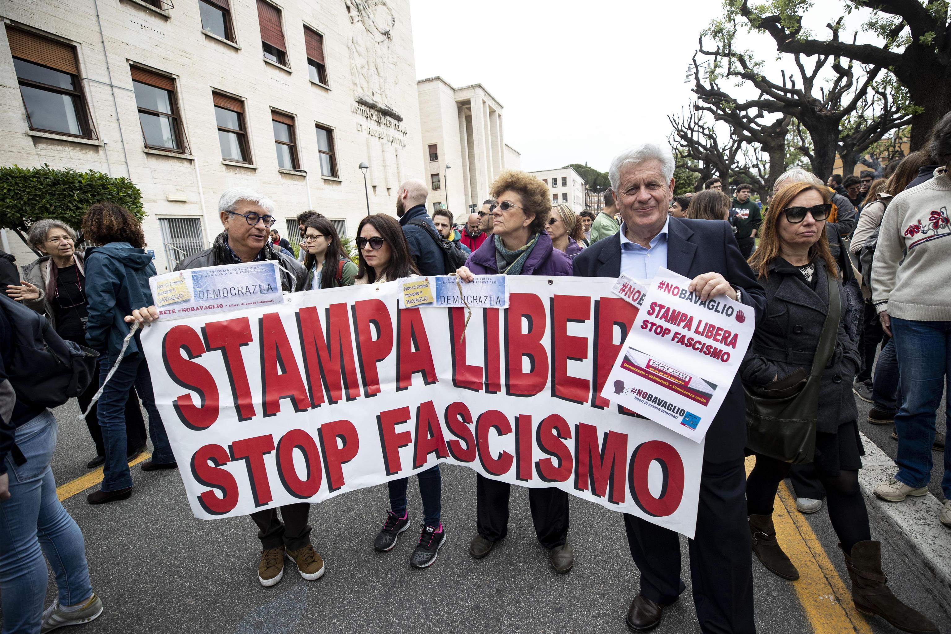 The anti-fascist demonstration awaiting the intervention of Mimmo Lucano, suspended mayor of Riace,  in Aldo Moro square in Rome, Italy, 13 May 2019. With a big banner in his head 