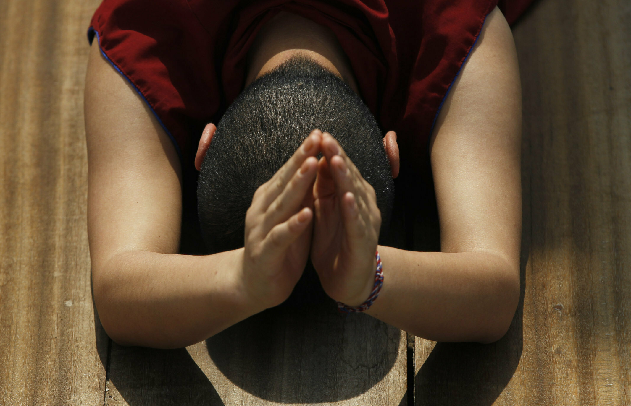 A Buddhist nun prostrates performing Buddhist religious rituals during Buddha Jayanti, or Buddha Purnima, festival in Kathmandu, Nepal, Saturday, May 18, 2019. The festival marks the triple events of Gautam Buddha's life: his birth, his enlightenment and his attaining a state of Nirvana that frees believers from the circle of death and rebirth. (AP Photo/Niranjan Shrestha)