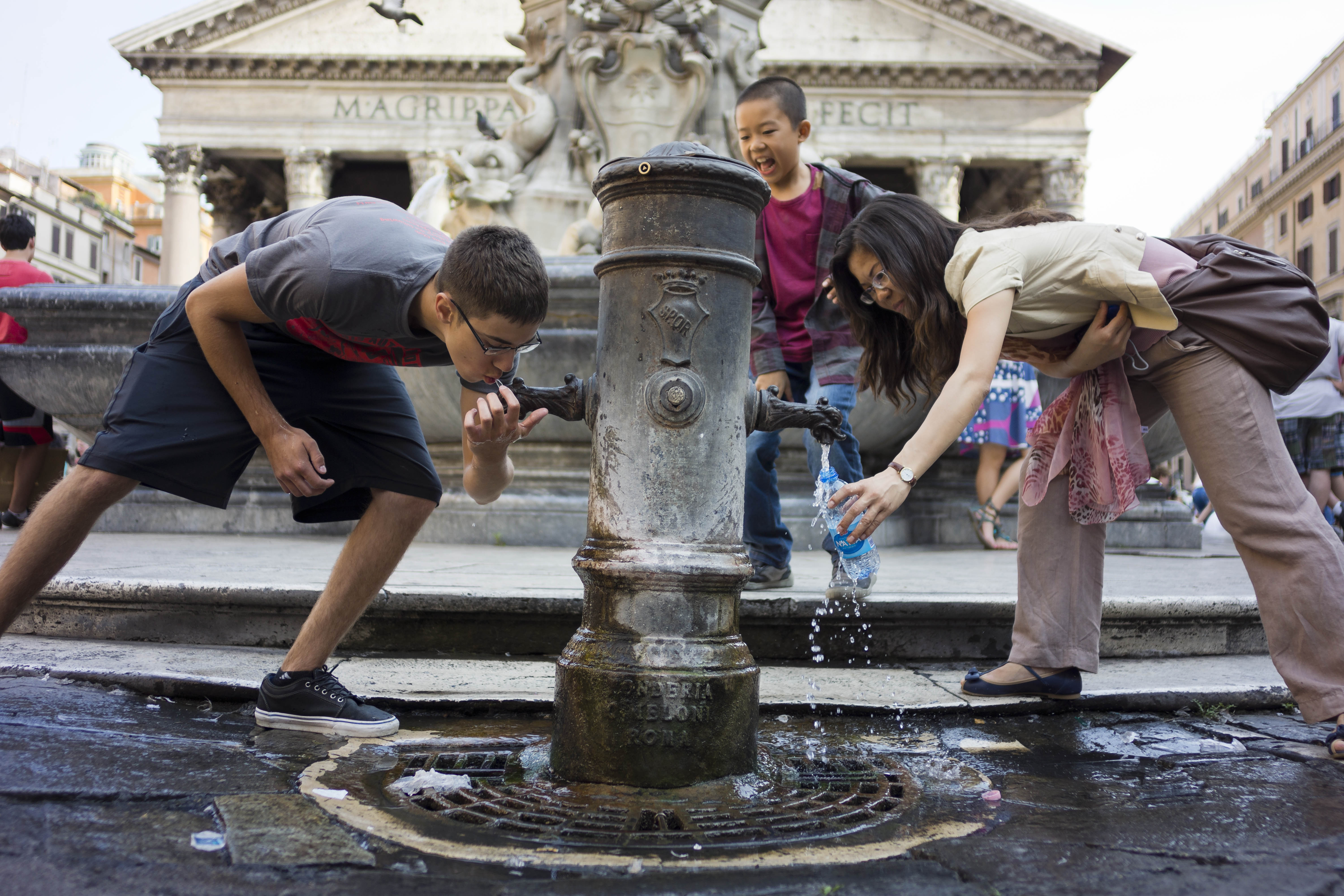 Tourists refresh at a typical Roman fountain (Nasone) in front of  Rome's Pantheon, Thursday, June 27, 2013. The Rome's Pantheon was  built under Roman Emperor Augustus between 27-25 BC to celebrate all Gods worshipped in ancient Rome and rebuilt under Emperor Adrian between 118 and 128 AD. The dome's central opening (Oculus) creates a beam of light that reflects on the temple's marble floor. ( AP Photo/Domenico Stinellis)