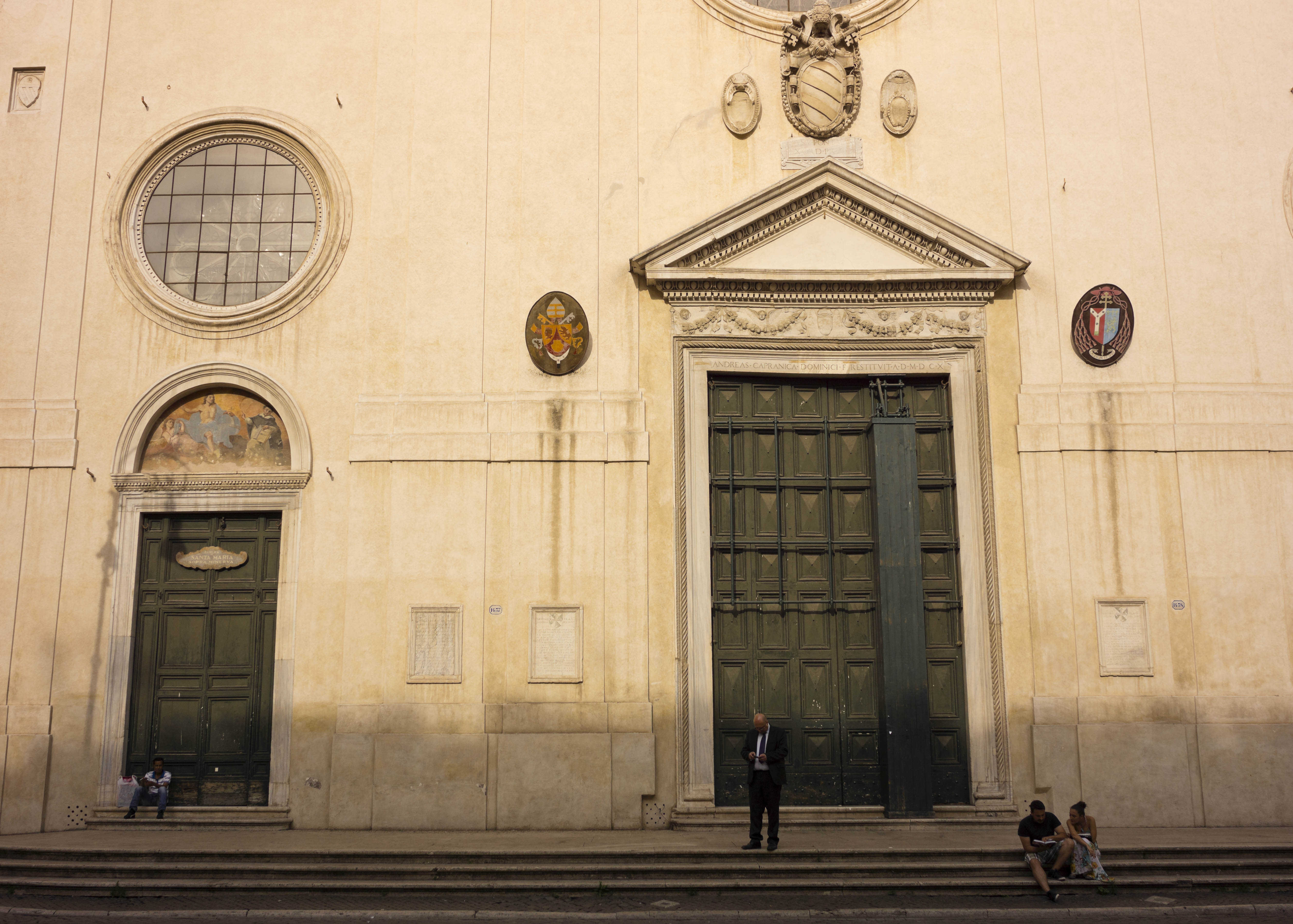 People take a break at dusk in front of  St. Mary over Minerva's Basilica (1566) in Rome, Thursday, June 27, 2013. ( AP Photo/Domenico Stinellis)