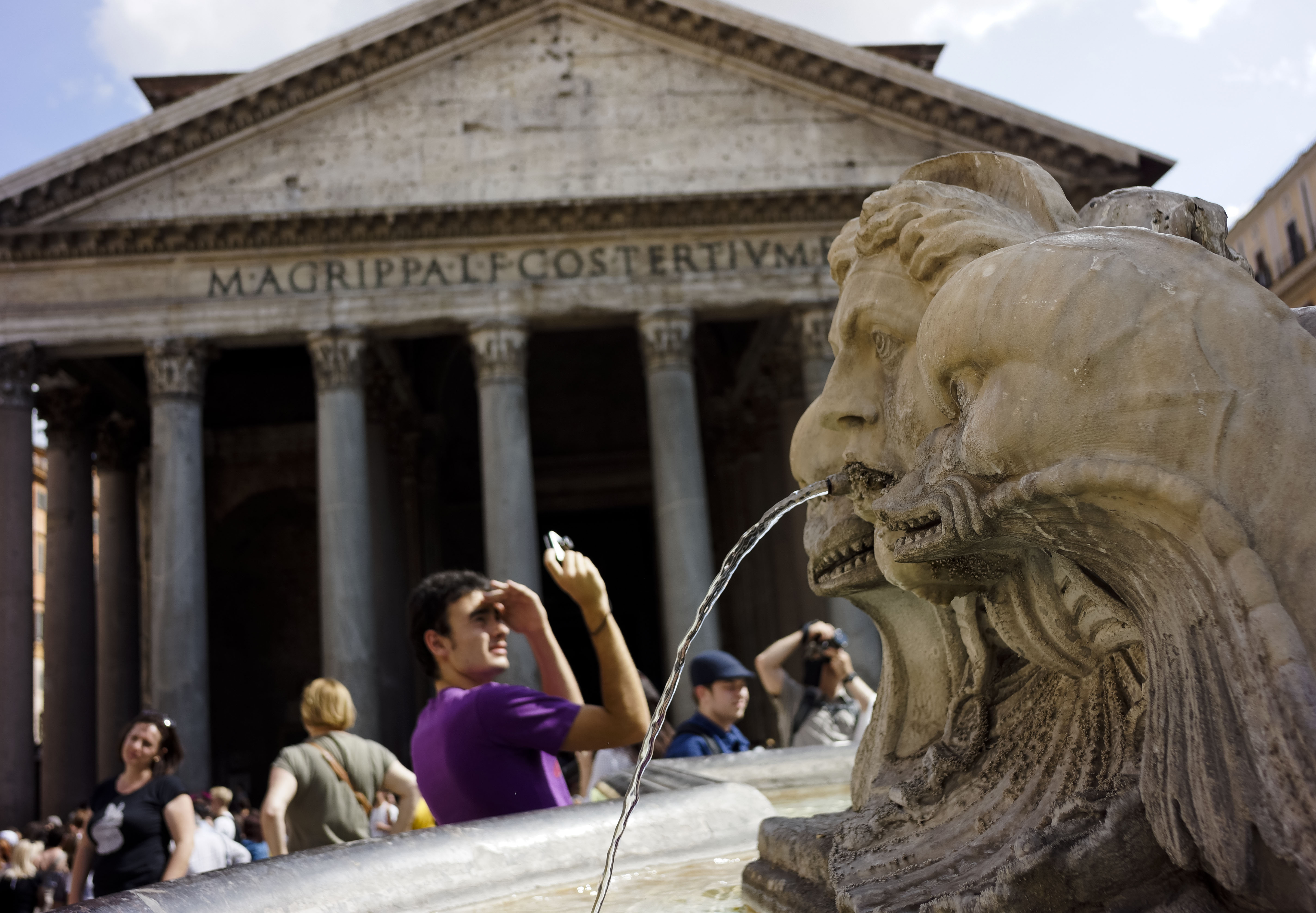 A man is framed by Giacomo Della Porta's 16th century fountain in Piazza della Rotonda, Rome, as he snaps a picture in front of the Pantheon, Friday, June 28, 2013. The Pantheon was built under Emperor Augustus between 27 and 25 b.C., to celebrate all the gods worshipped in Ancient Rome. (AP Photo, Domenico Stinellis)