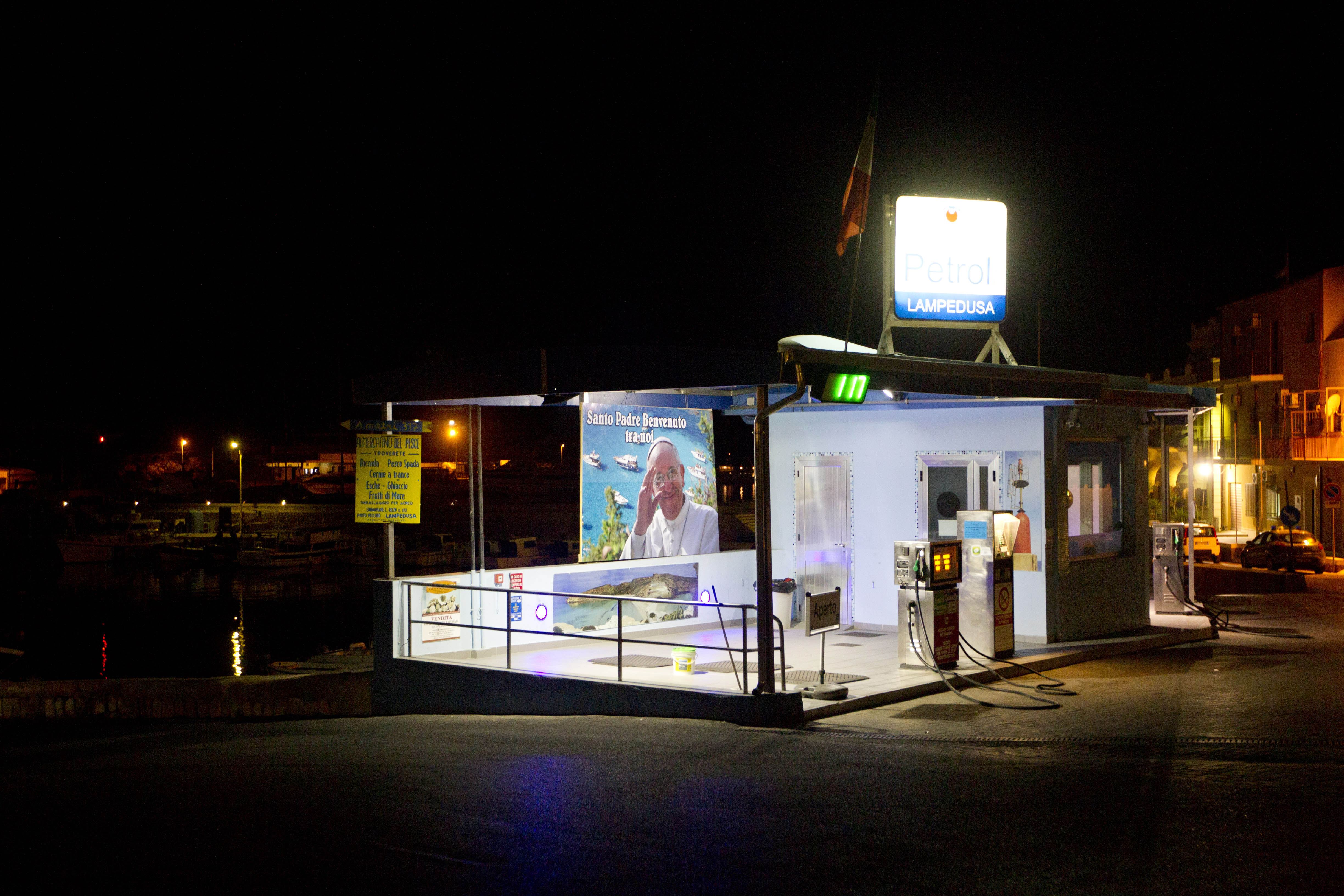 A giant  portrait of Pope Francis hangs from a petrol station in Lampedusa early Tuesday July 9, 2013 (AP Photo/Alessandra Tarantino)