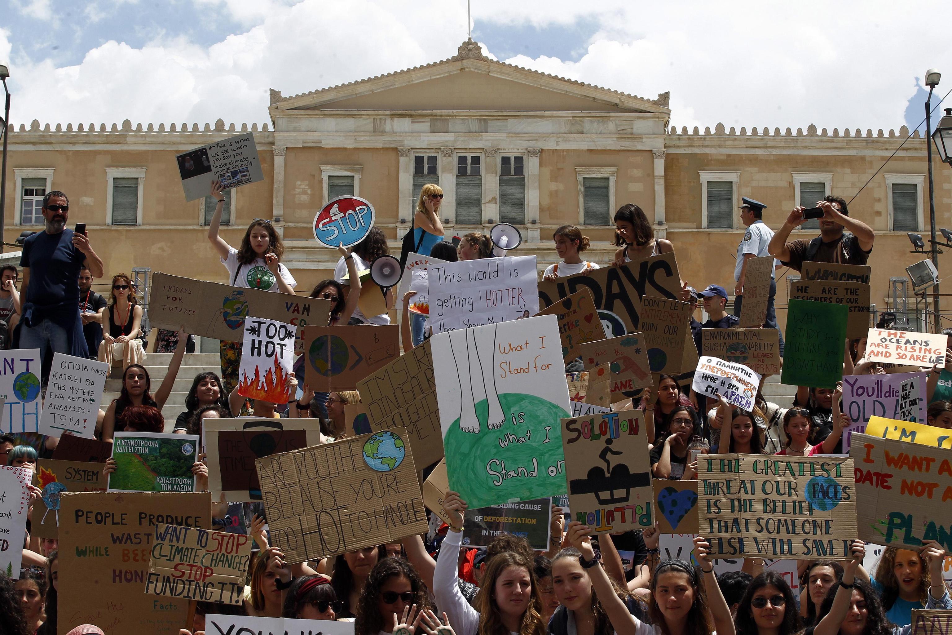 epa07597089 Students take part in a demonstration against climate change during a 'Fridays for Future' in front of the greek parliament, in Athens, Greece, 24 May 2019. Youth and students across the world are taking part in a student strike movement called #FridayForFuture which was sparked by Greta Thunberg of Sweden, a sixteen year old climate activist who has been protesting outside the Swedish parliament every Friday since August 2018.  EPA/ALEXANDROS VLACHOS