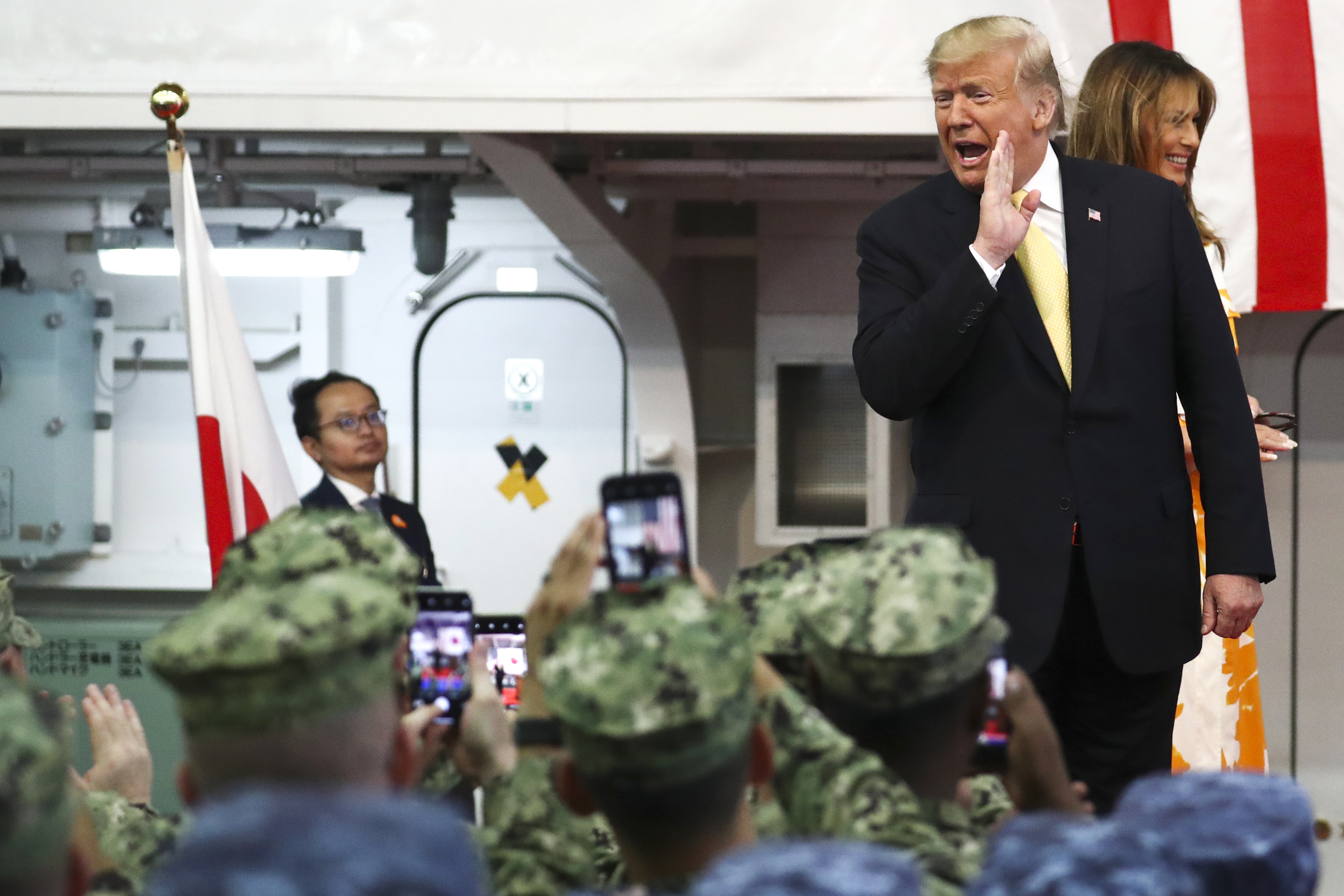 U.S. President Donald Trump and first lady Melania Trump react during delivering a speech to Japanese and U.S. troops as they aboard Japan Maritime Self-Defense Force's (JMSDF) helicopter carrier DDH-184 Kaga at JMSDF Yokosuka base in Yokosuka, south of Tokyo Tuesday, May 28, 2019. (Athit Perawongmetha/Pool Photo vi AP)
