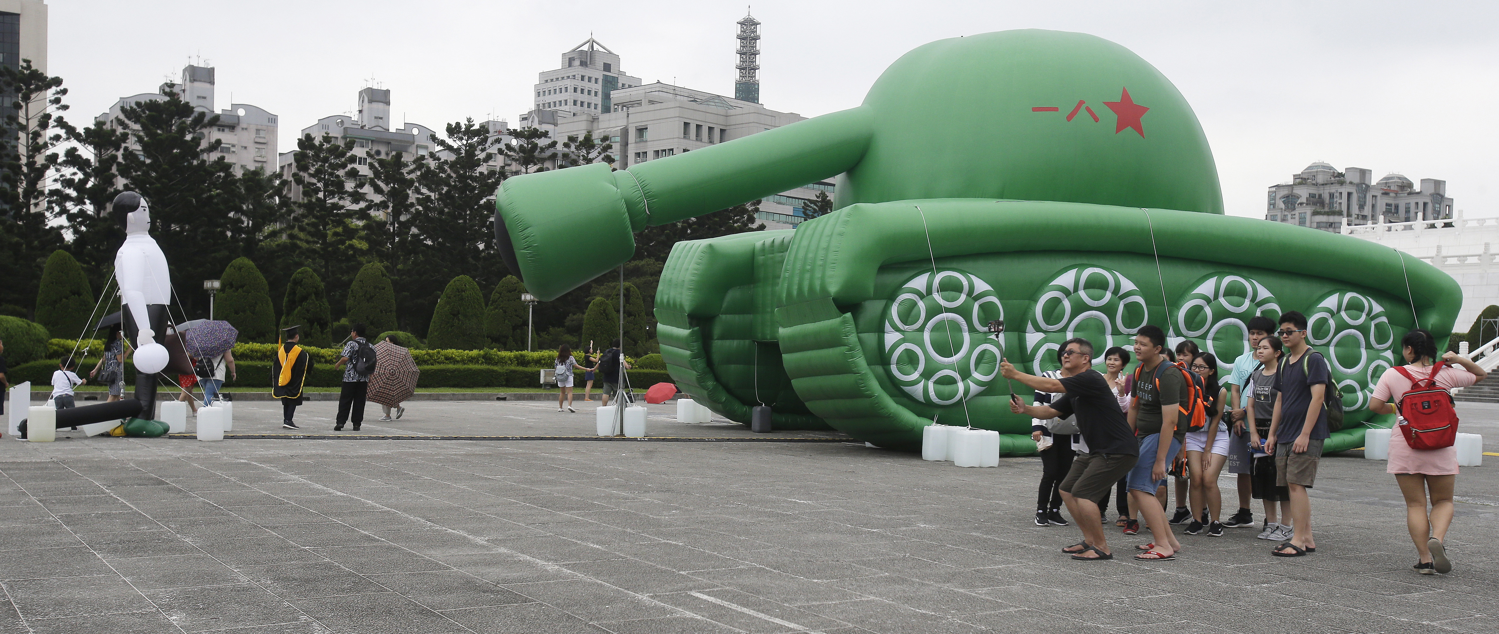 Chinese tourists take a selfie with an inflatable tank man at the Liberty Square of Chiang Kai-shek Memorial Hall in Taipei, Taiwan, Saturday, June 1, 2019. An artist erected the inflatable display in Taiwan’s capital to mark an iconic moment in the Tiananmen Square pro-democracy protests. The larger-than-life balloon installation, which stands in front of Taipei’s famous hall, portrays a peaceful encounter between a Chinese civilian and the military tanks that contributed to a brutal shutdown of the demonstrations in Beijing on June 4, 1989. (AP Photo/Chiang Ying-ying)