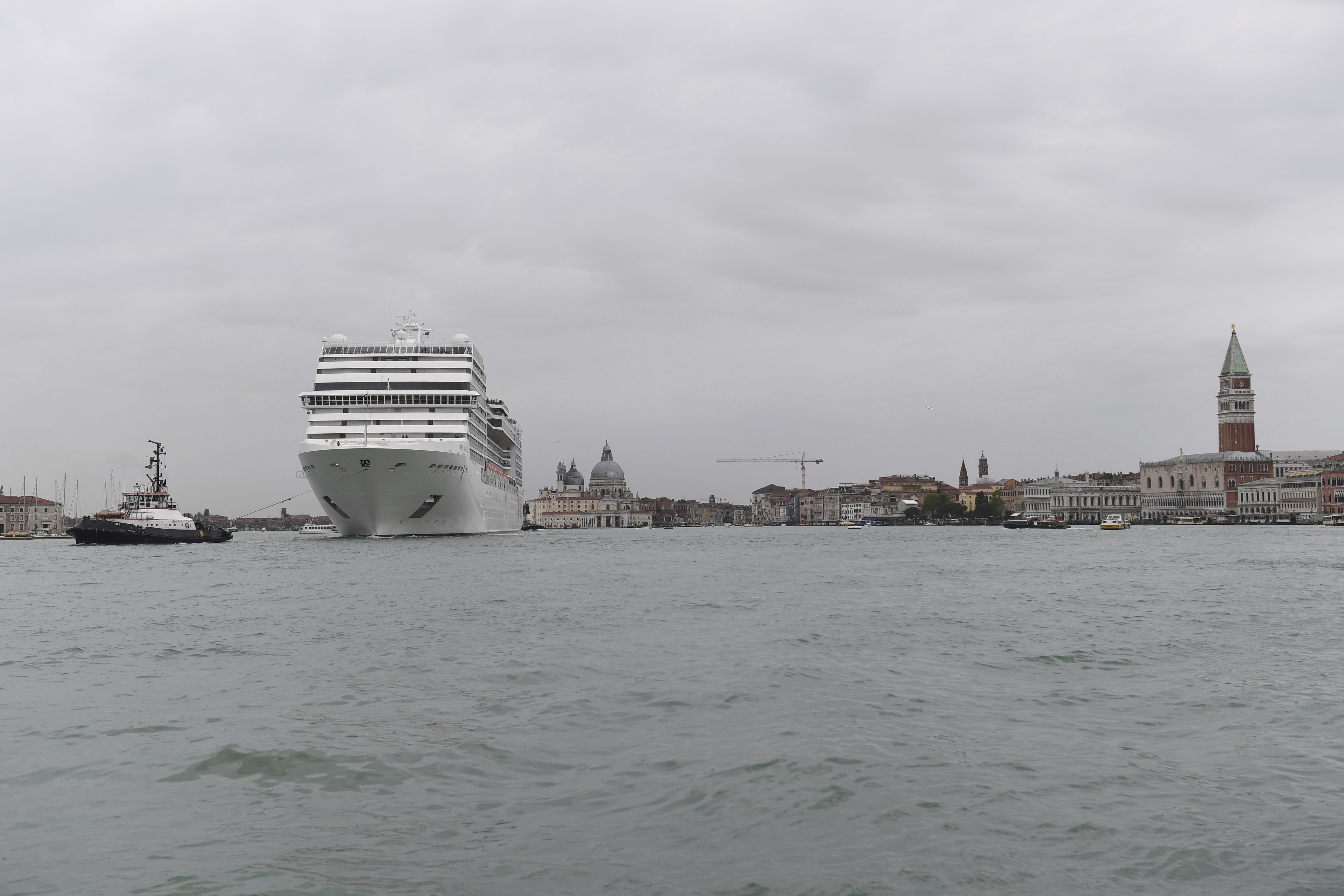 12 May 2019, Italy, Venedig: A cruise ship passes the lagoon city Venice pulled by a tug. The international art exhibition starts on 11.05.2019 and ends on 24.11.2019. Photo by: Felix H'rhager/picture-alliance/dpa/AP Images