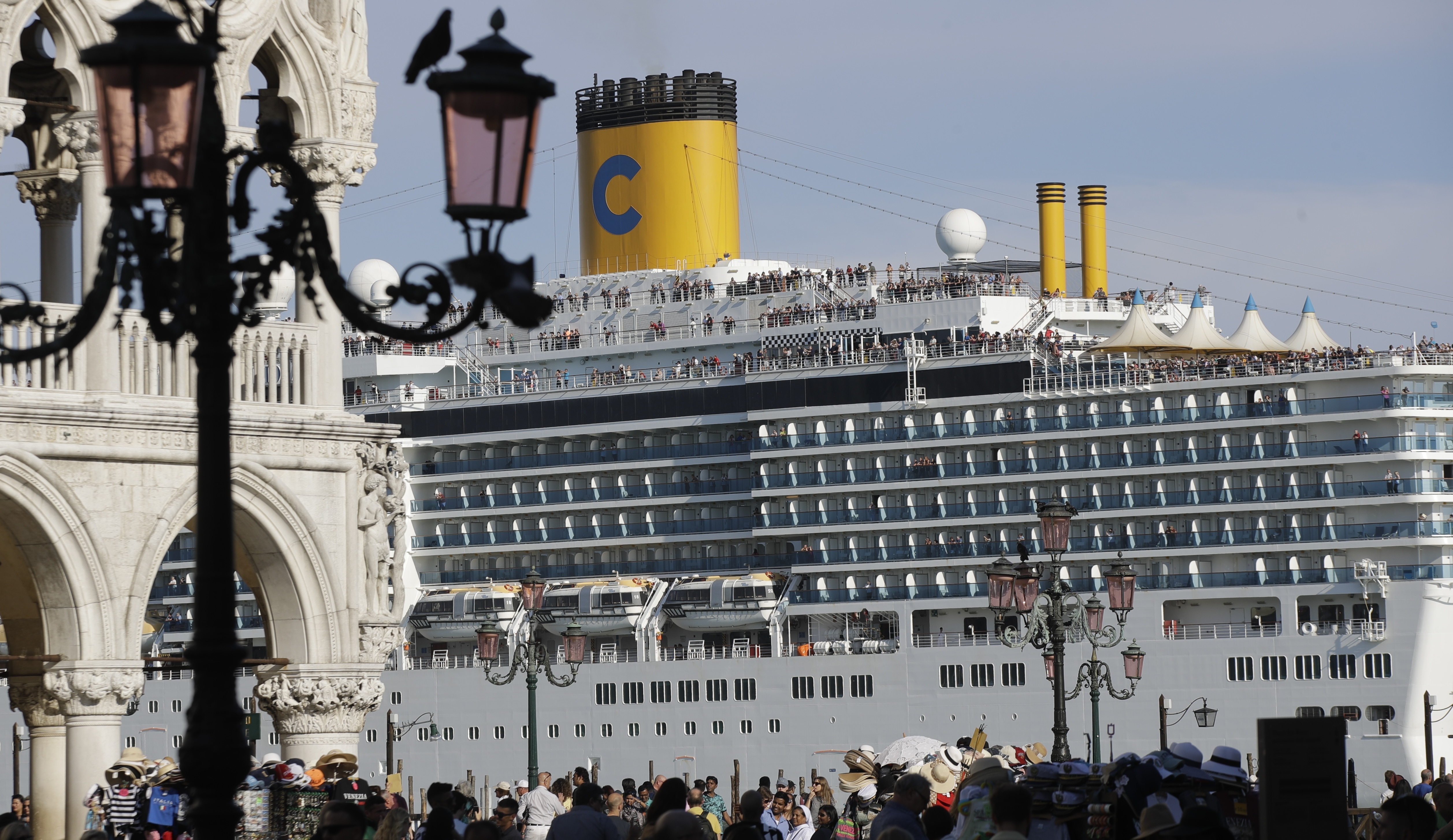 A cruise ship passes by St. Mark's Square in Venice, Italy, Sunday, June 2, 2019. Groups that want to ban cruise ships on Venice's busy canals say a collision that injured four tourists has served as a wake-up call. Opponents say cruise ships are out-of-scale for Venice, cause pollution, threaten the lagoon's ecosystem and dangerous. (AP Photo/Luca Bruno)