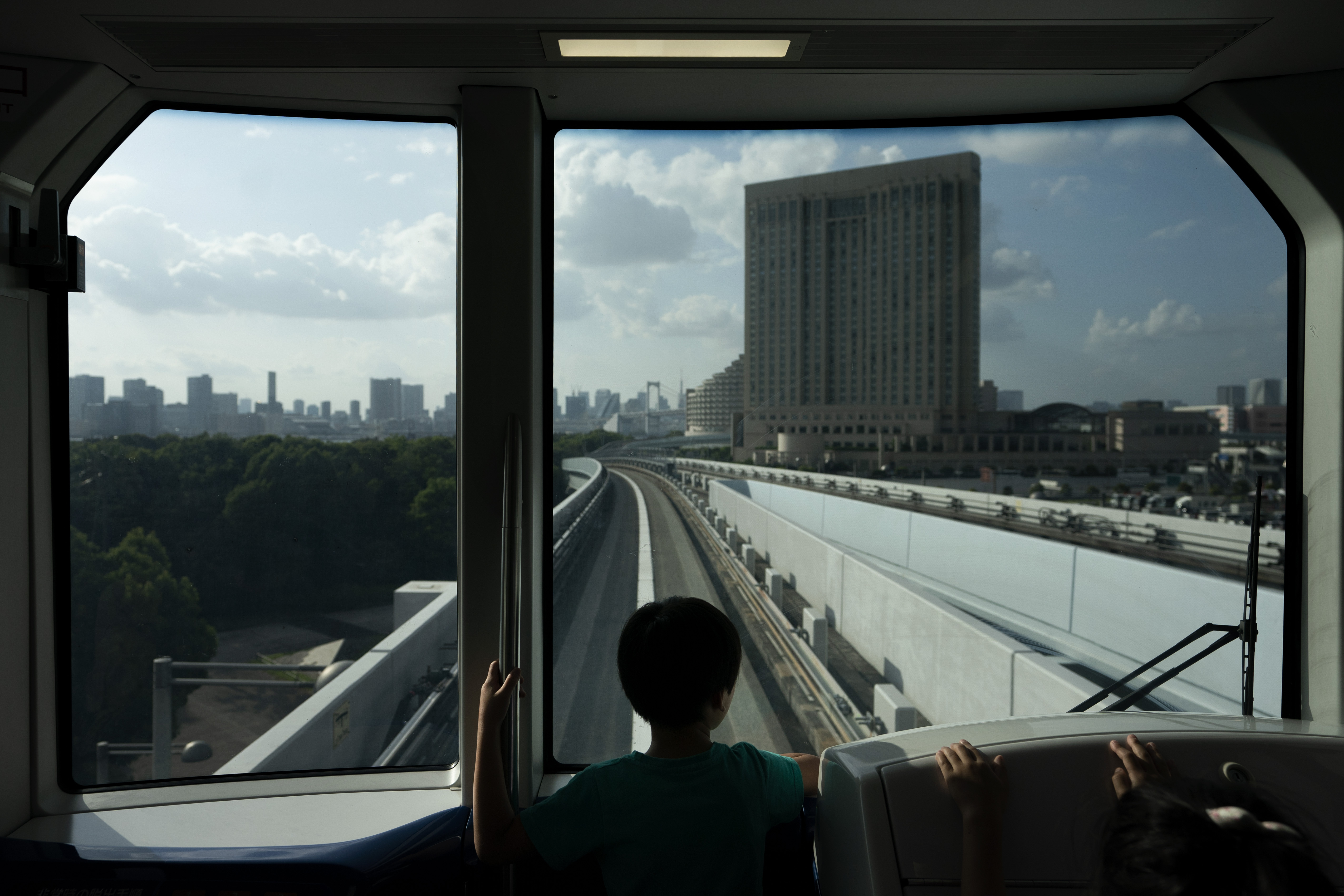 A young boy views the Tokyo skyline in the distance from a train running along the Yurikamome line Sunday, May 19, 2019, in Tokyo. (AP Photo/Jae C. Hong)