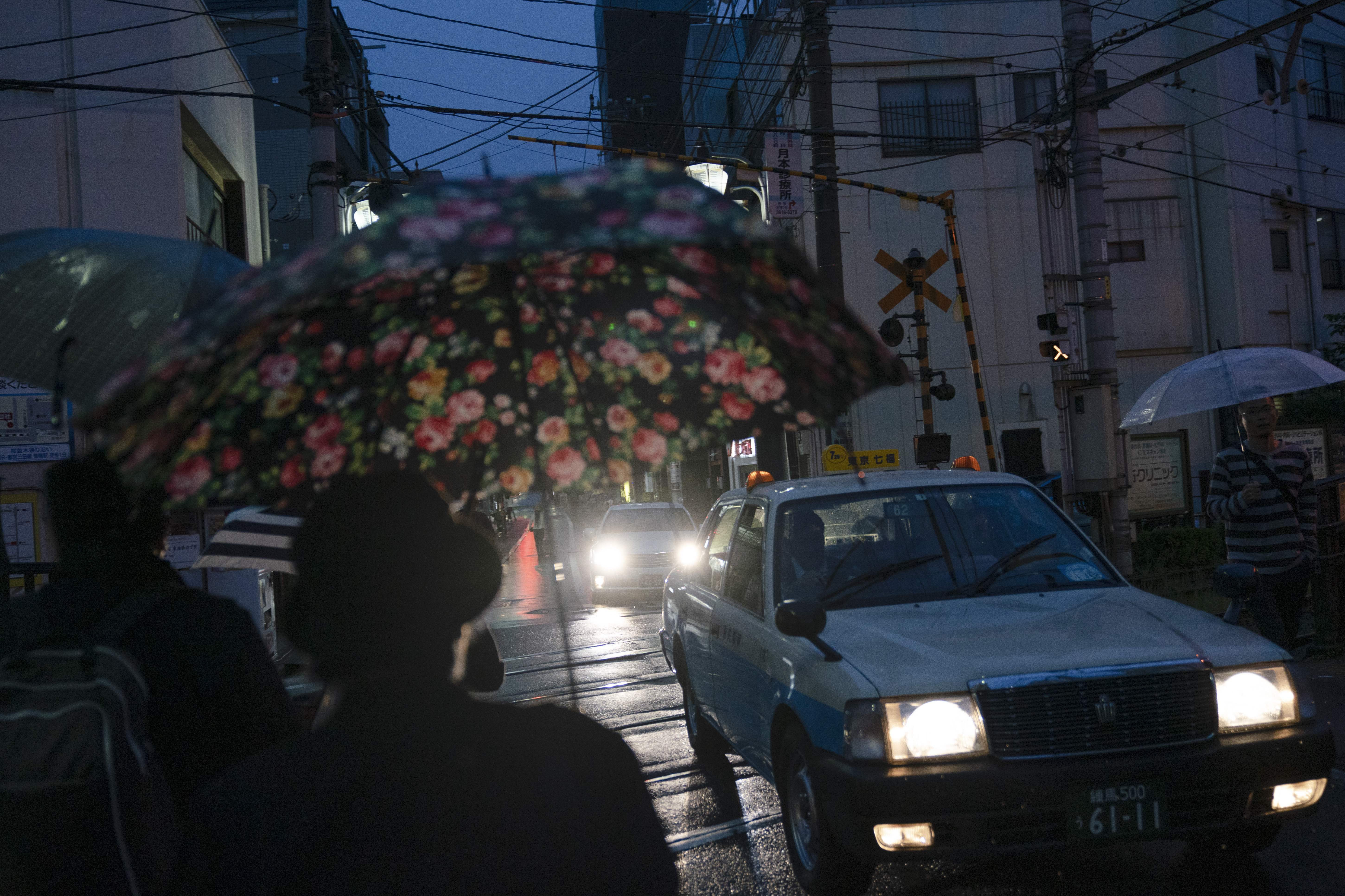 A Taxi drives through Jizo Dori in the rain, a shopping street in Tokyo's Sugamo district widely known as 