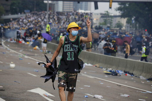 A protester gestures after clashes with riot police during a massive demonstration outside the Legislative Council in Hong Kong, Wednesday, June 12, 2019. Hong Kong police fired tear gas and rubber bullets at protesters who had massed outside government headquarters Wednesday in opposition to a proposed extradition bill that has become a lightning rod for concerns over greater Chinese control and erosion of civil liberties in the territory. (AP Photo/Kin Cheung)