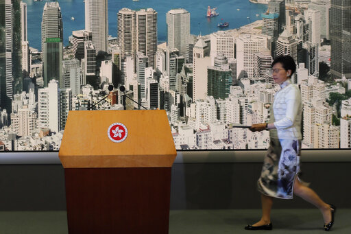Hong Kong's Chief Executive Carrie Lam arrives at a press conference in Hong Kong Saturday, June 15, 2019. Lam said she will suspend a proposed extradition bill indefinitely in response to widespread public unhappiness over the measure, which would enable authorities to send some suspects to stand trial in mainland courts. (AP Photo/Kin Cheung)