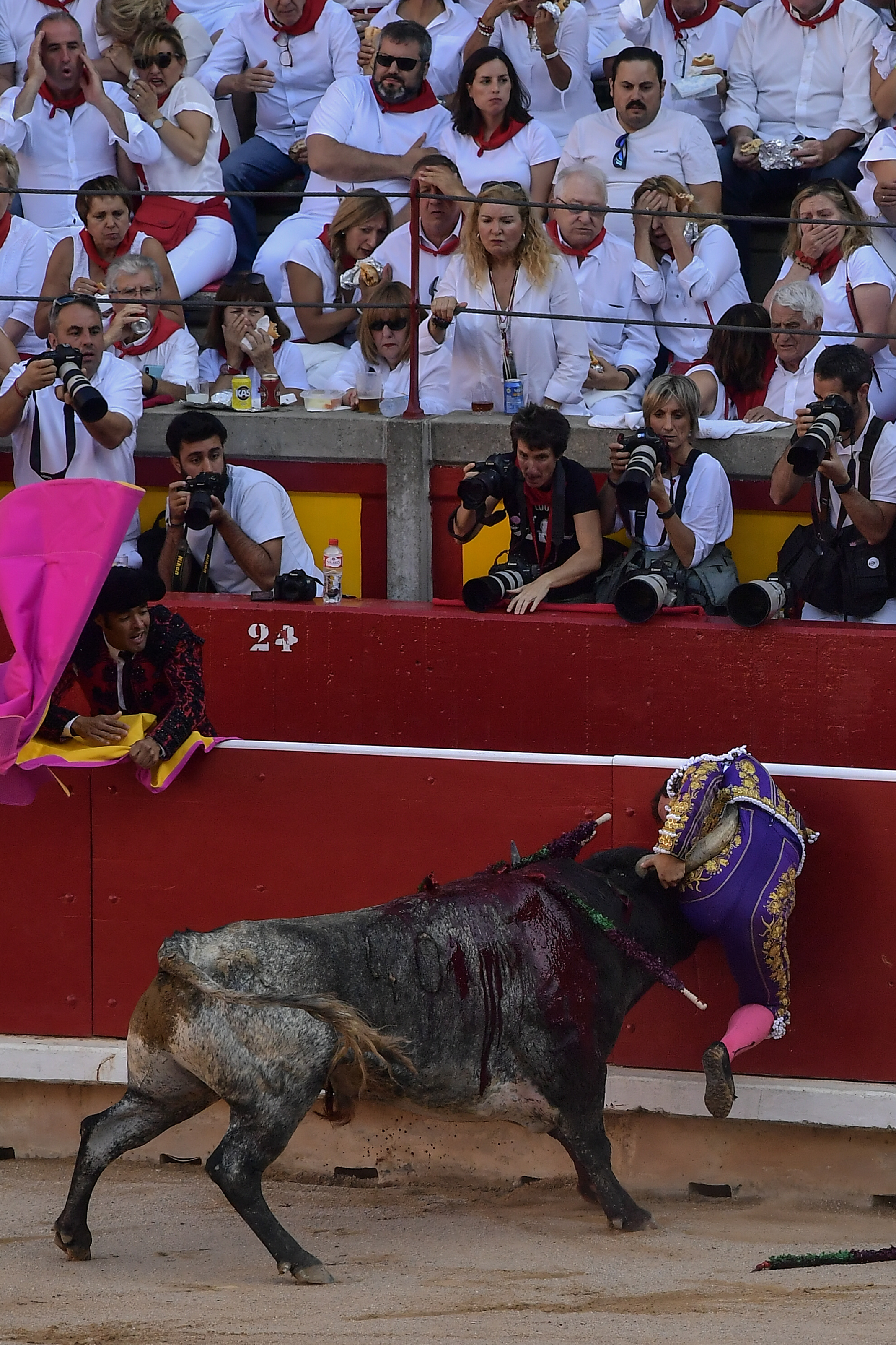 Spanish bullfighter Rafaelillo is gored by bull during bullfight at the San Fermin Festival in Pamplona, northern Spain, Sunday, July 14, 2018. Revelers from around the world flock to Pamplona every year to take part in the eight days of the running of the bulls, and say good bye today with the sing ''Pobre de Mi'' in the midnight. (AP Photo/Alvaro Barrientos)