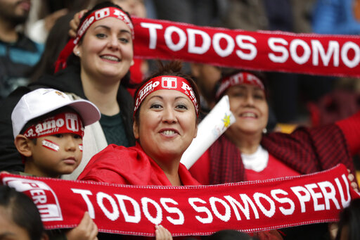 Spectators hold scarfs reading in Spanish 