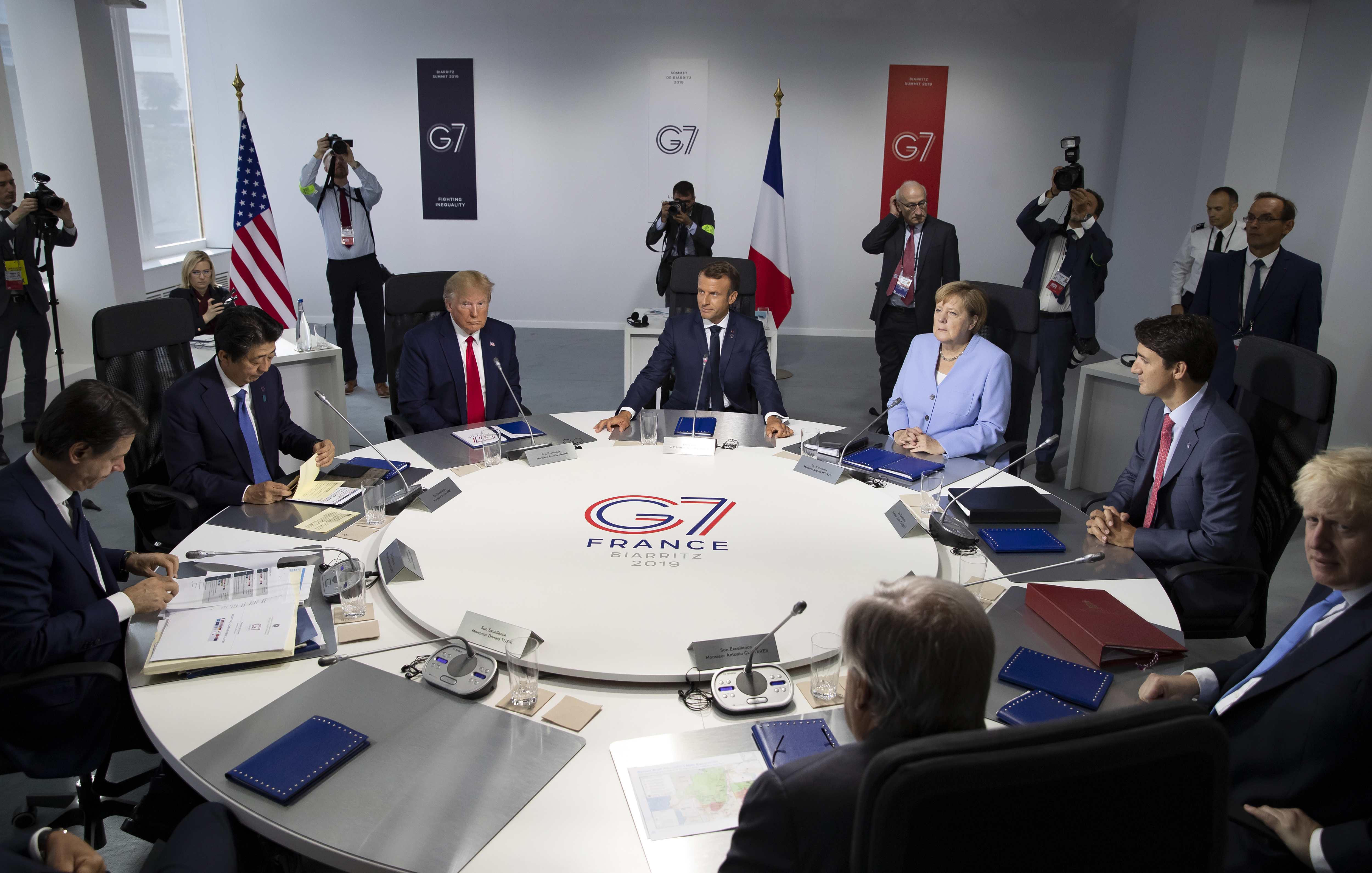 From the left, Italian Prime Minister, Giuseppe Conte, Japanese Prime Minister Shinzo Abe, U.S President Donald Trump, French President Emmanuel Macron, German Chancellor Angela Merkel, Canadian Prime Minister Justin Trudeau, Britain's Prime Minister Boris Johnson attend a work session during the G7 summit at Casino in Biarritz, southwestern France, Monday Aug.26 2019. G-7 leaders are wrapping up a summit dominated by tensions over U.S. trade policies and a surprise visit by Iran's top diplomat. (Ian Langsdon, Pool via AP)