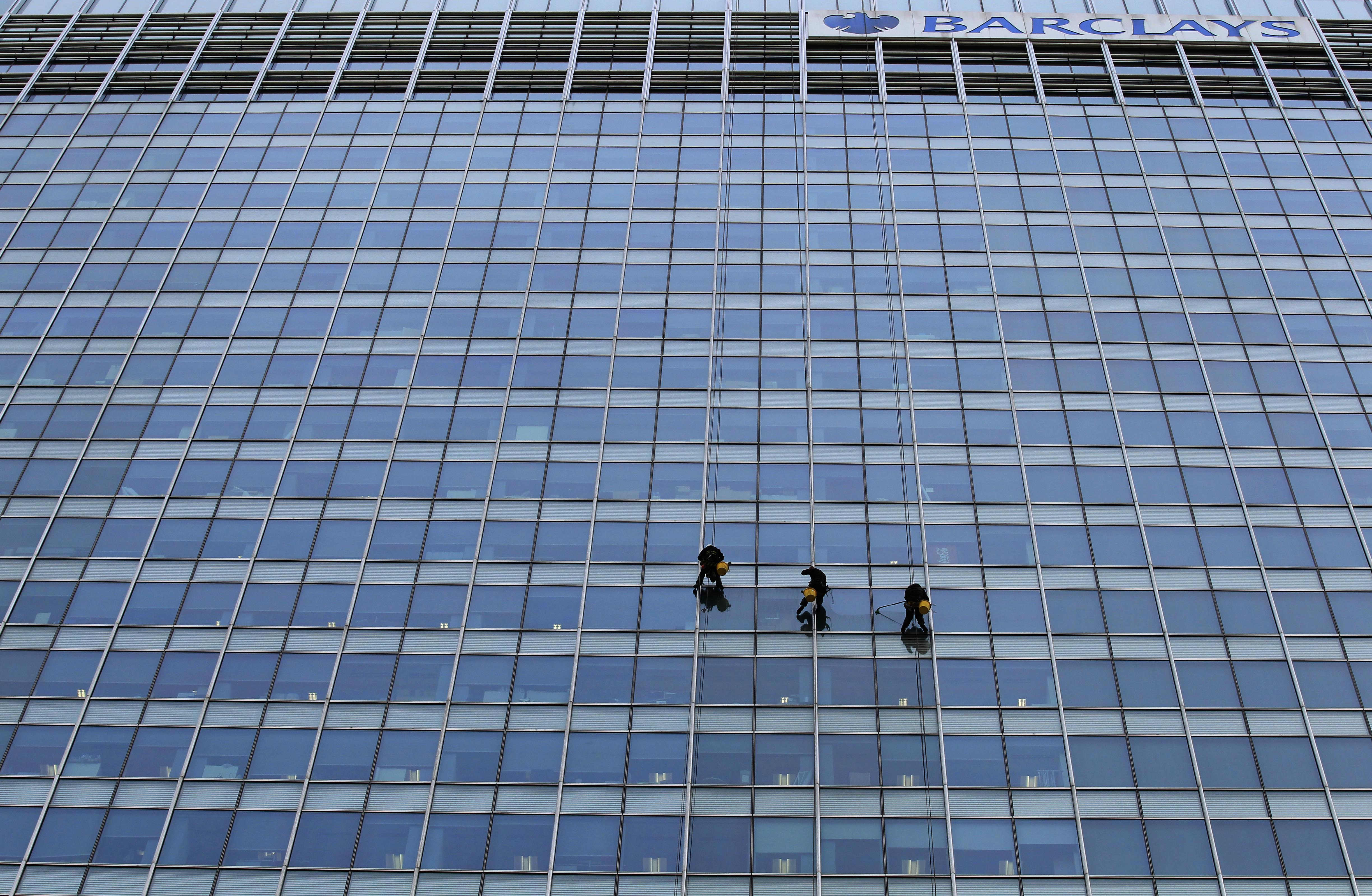 Workers clean the side of the One Churchill Place skyscraper, of which 32 floors serve as the headquarters of Barclays Bank, in the Canary Wharf business district of London, Friday, May 6, 2011.  (AP Photo/Matt Dunham)