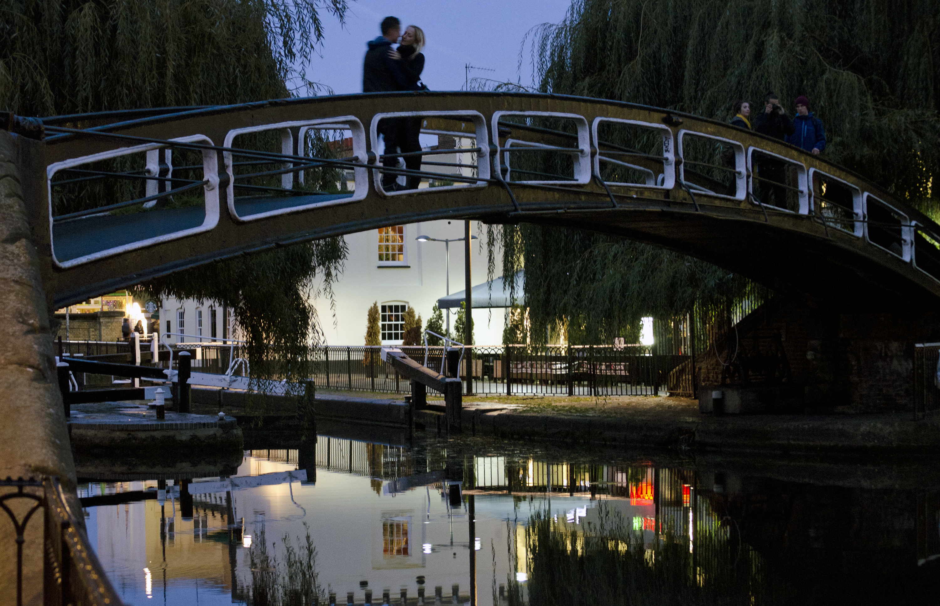 A couple embrace on a bridge over a canal in Camden Lock, North London, Wednesday, Oct. 26, 2011.(AP Photo/John R Moore)
