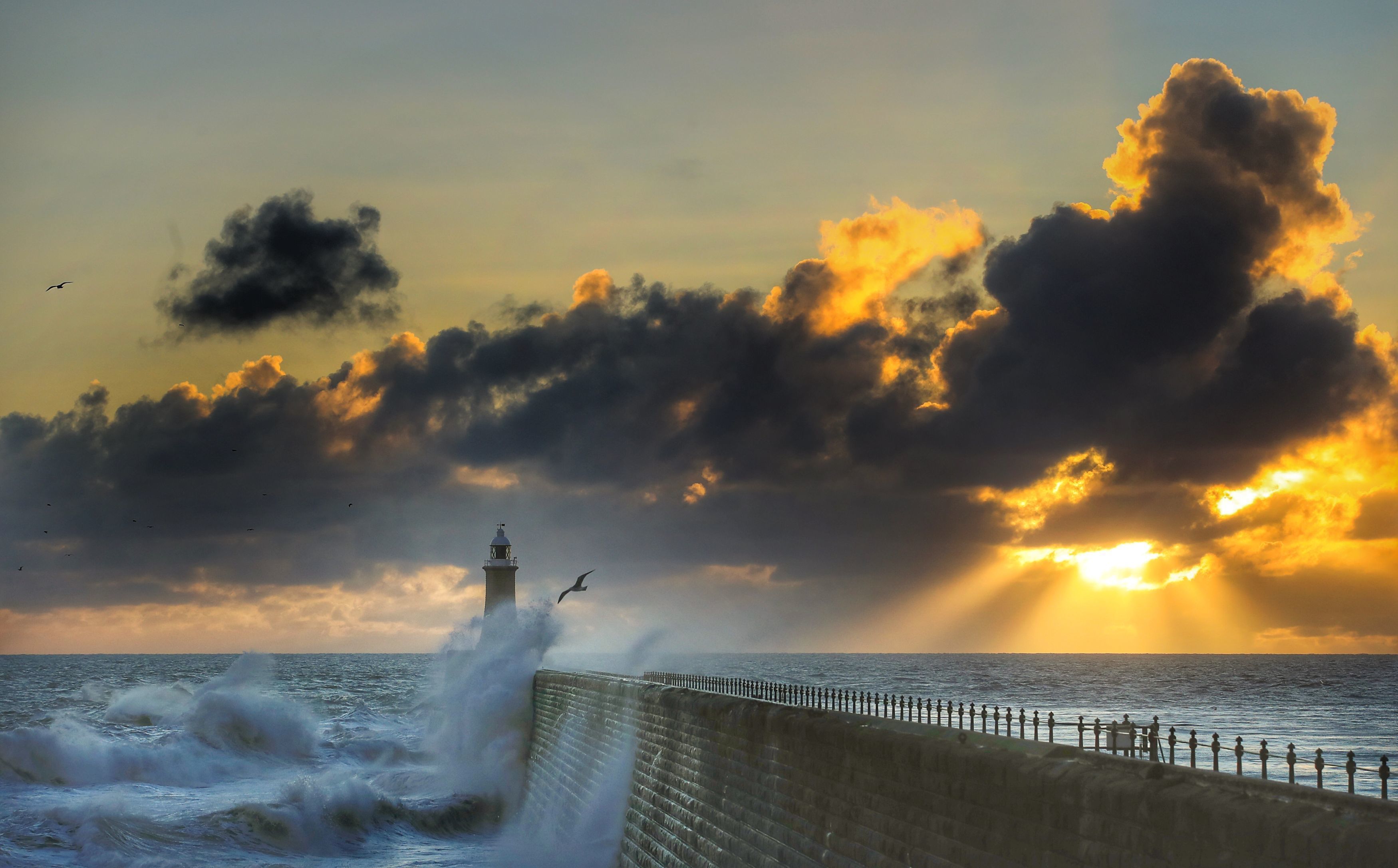 Rough seas are buffeted against Tynemouth Pier, as the sun rises in Tynemouth, England, Sunday, Oct. 28, 2018. (Owen Humphreys/PA via AP)
