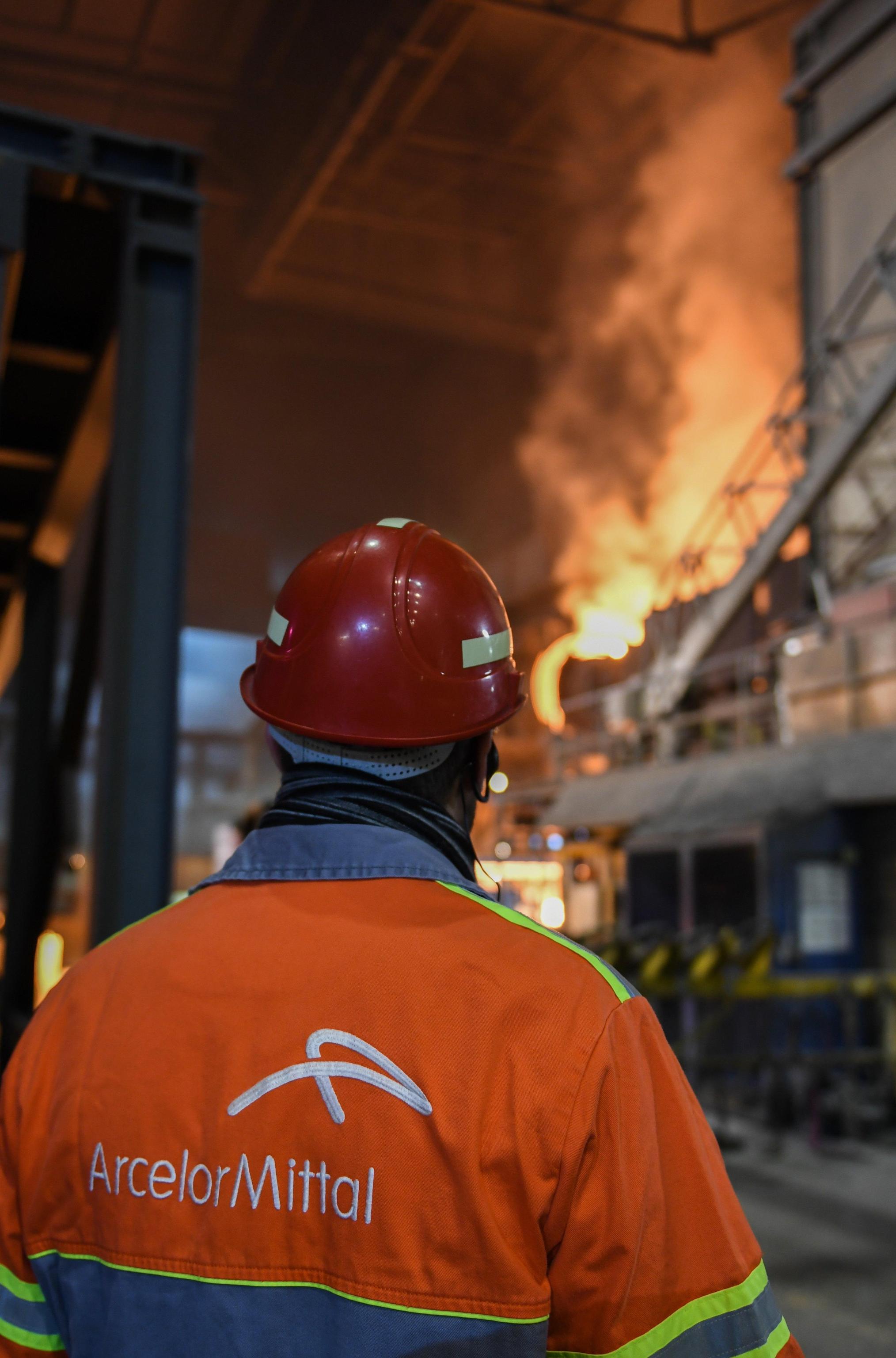 epa06357494 An employee of  the company Arcelor Mittal watches the blast furnace in Hamburg, Germany, 29 November 2017. The company opens three wind power plants on its ground. The turbines should help to cover the energy requirements of the steel production. The wind power plants are able to produce more than 23.000 megawatt hours. The blast furnace exhausted some 830 Giga watt hours energy a year.  EPA/DAVID HECKER